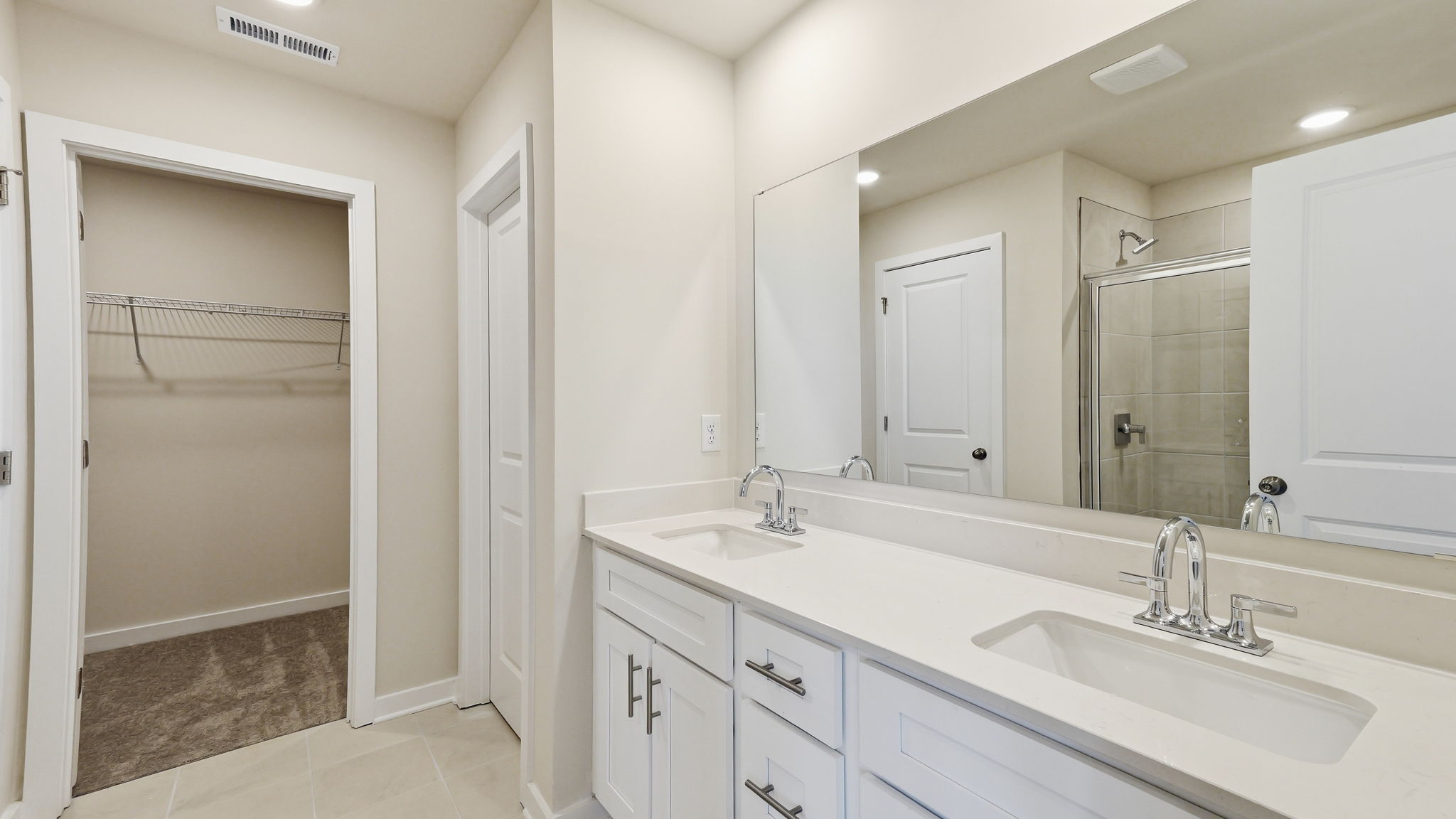 A bathroom with a large mirror.