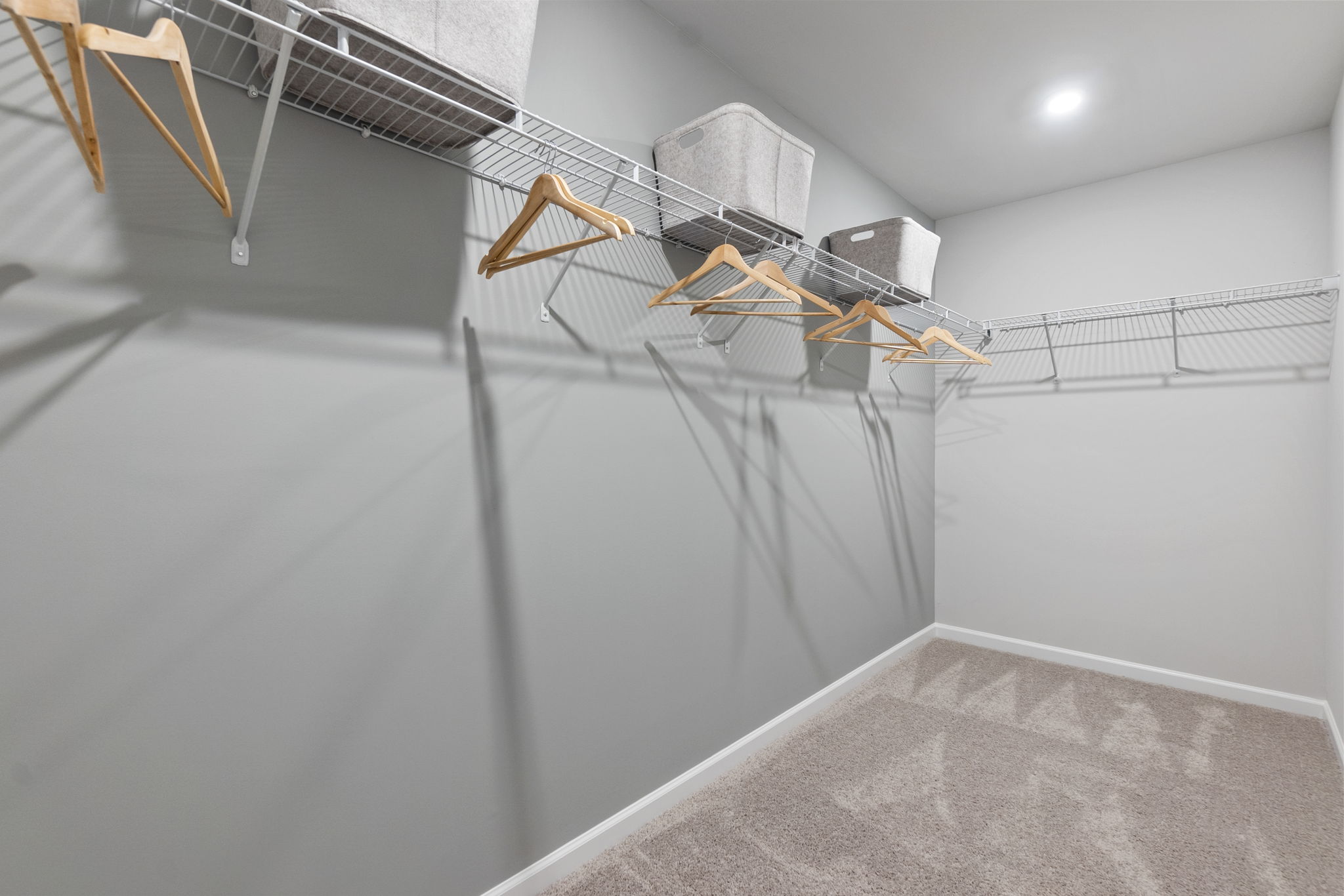 A white room with a white wall and a metal railing.