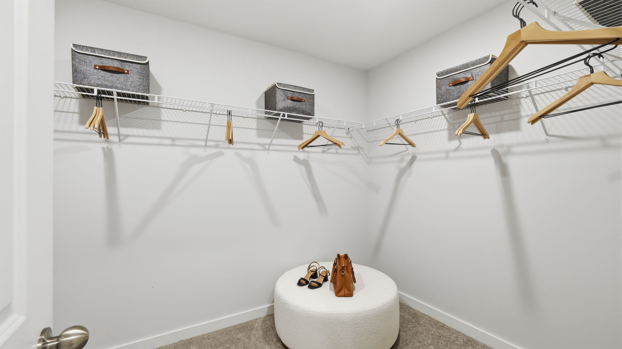 A toilet with a shelf above it.