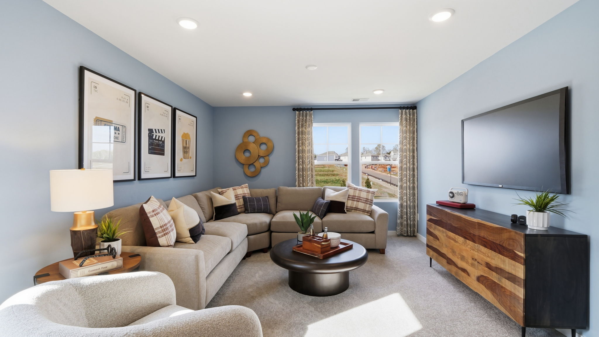 A living room with a large tv and a couch.
