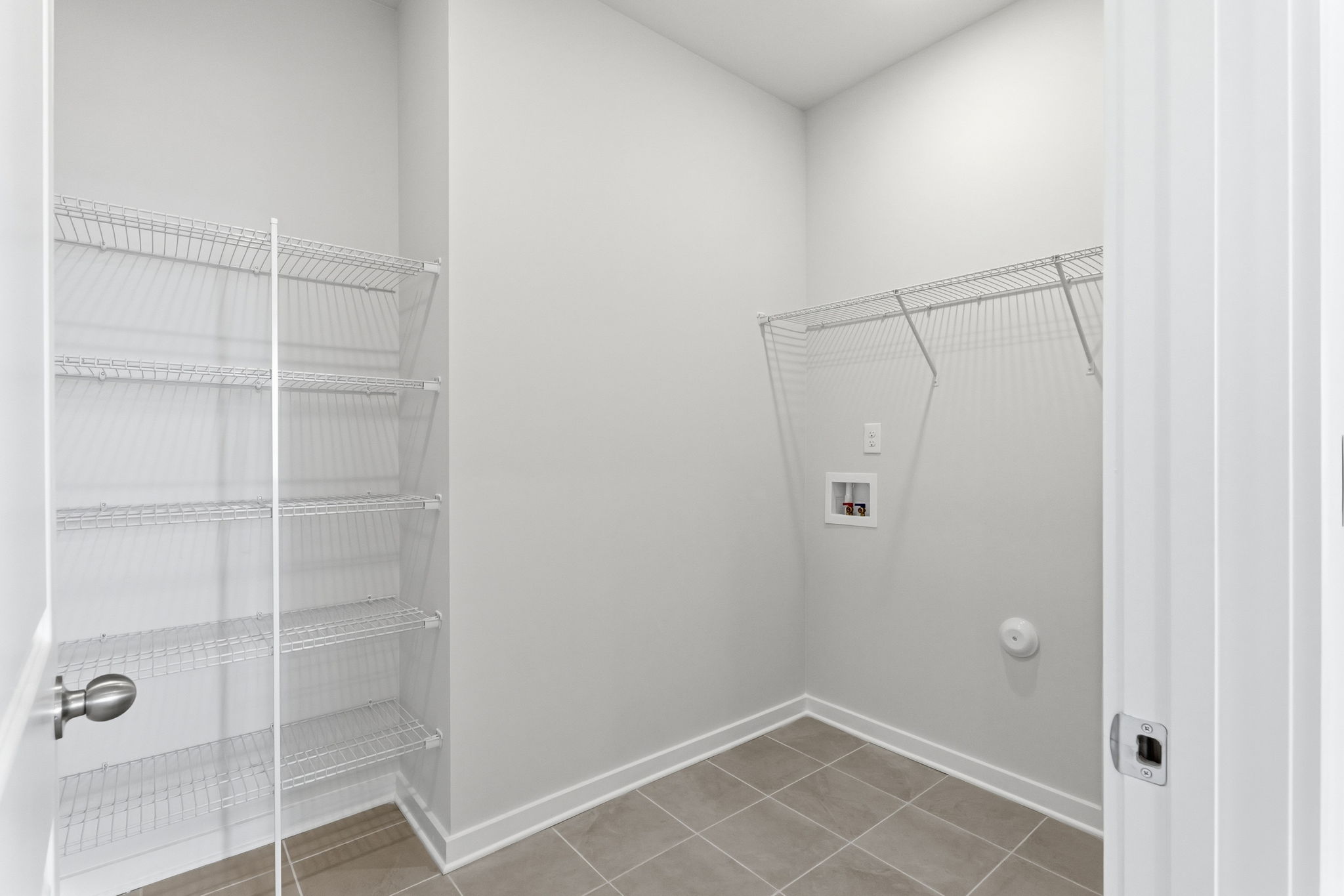 A white room with a metal rack.