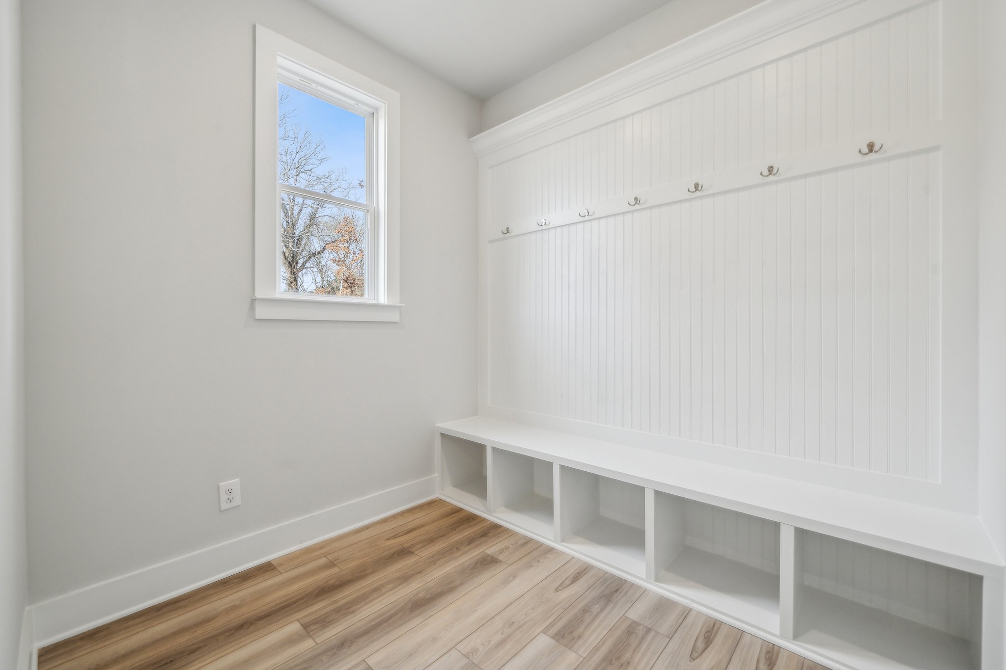 A room with white walls and a wood floor.