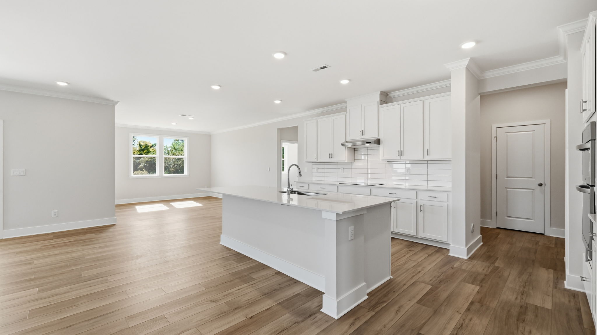 A kitchen with white cabinets.