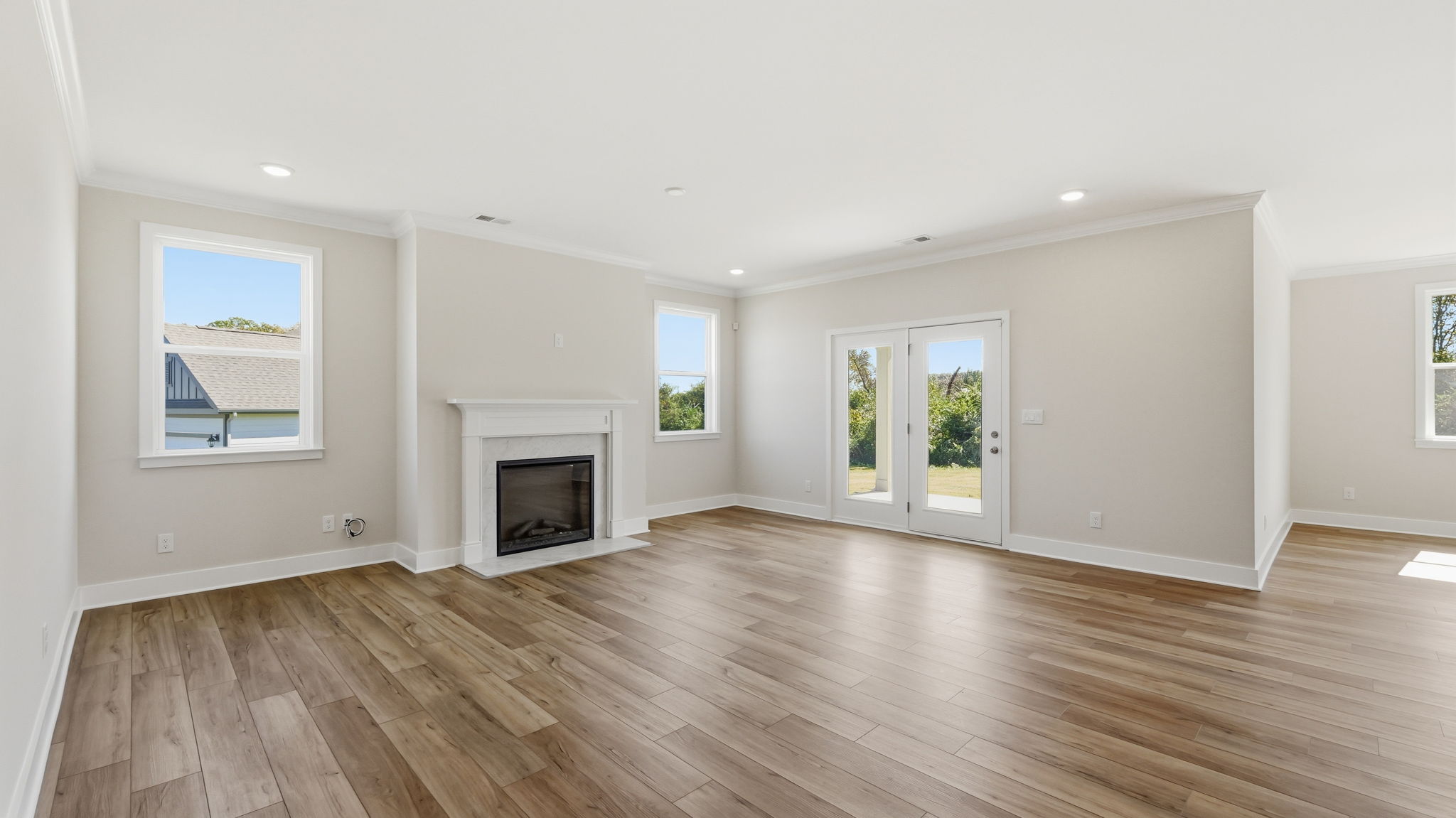 A room with a fireplace and a wood floor.