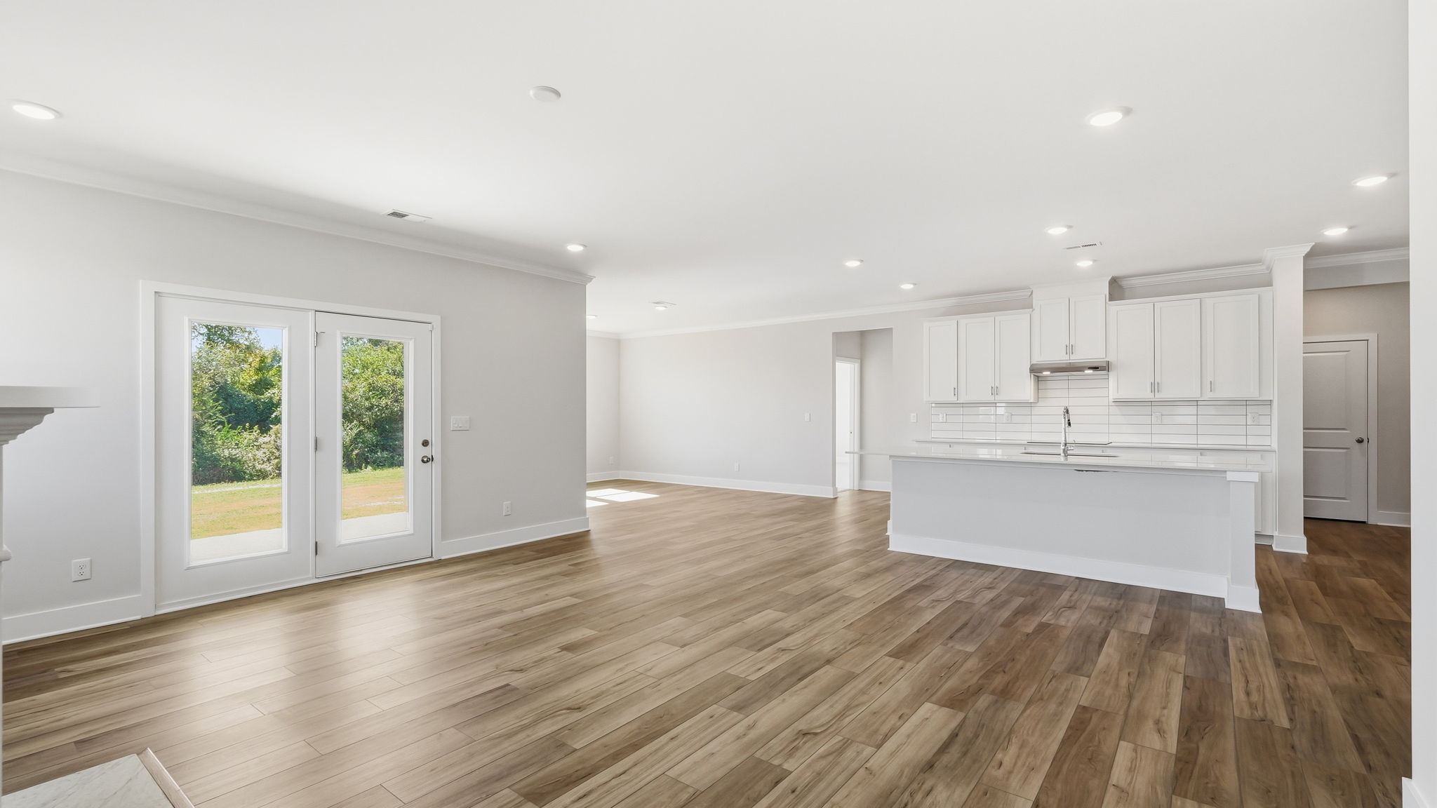 A large white kitchen with white cabinets.