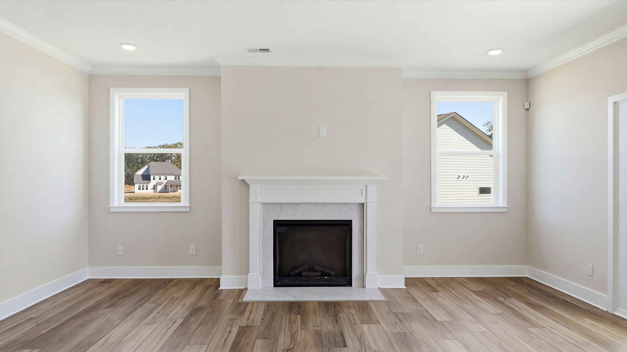 A room with a fireplace and a wood floor.