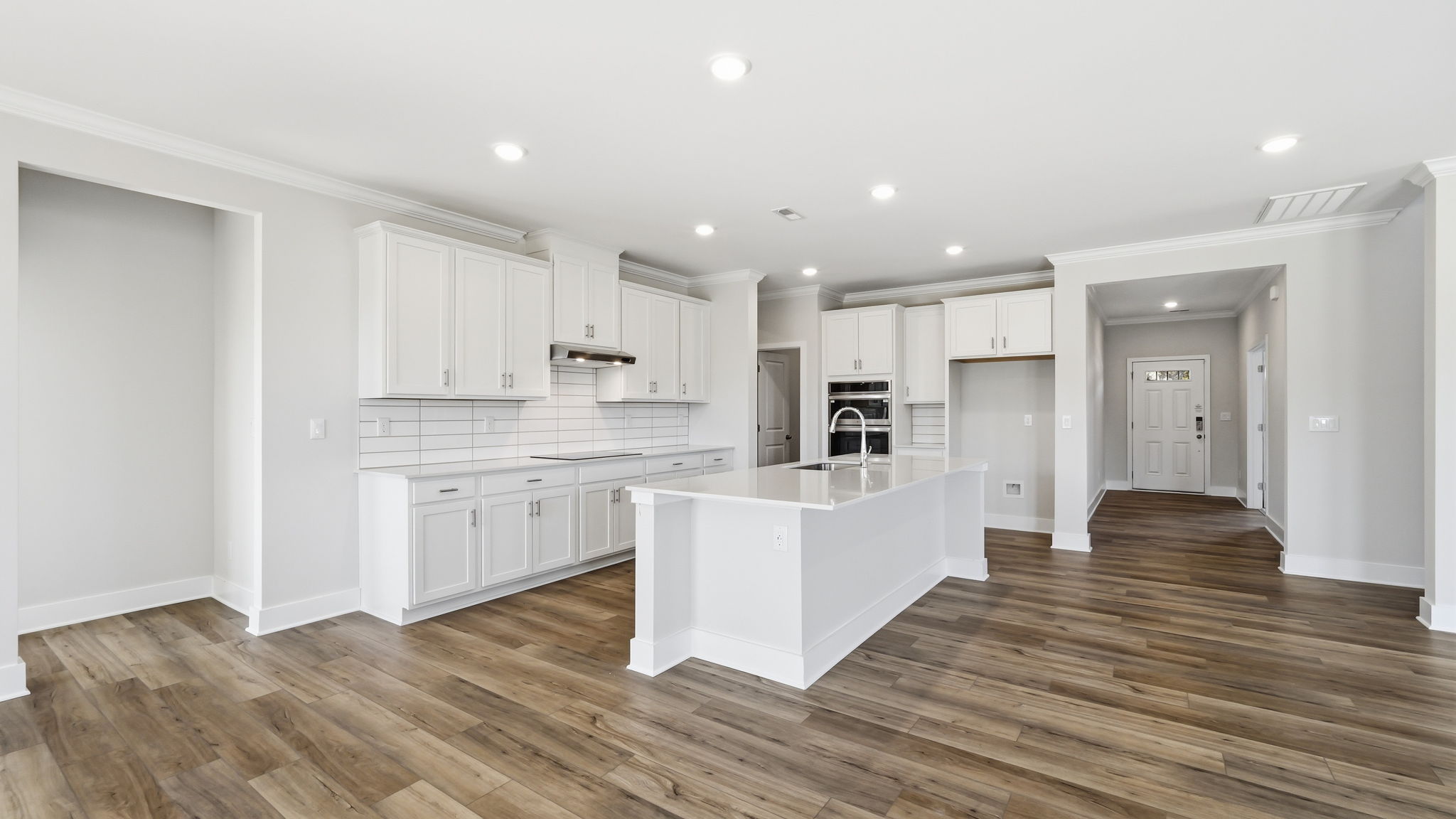 A kitchen with white cabinets.