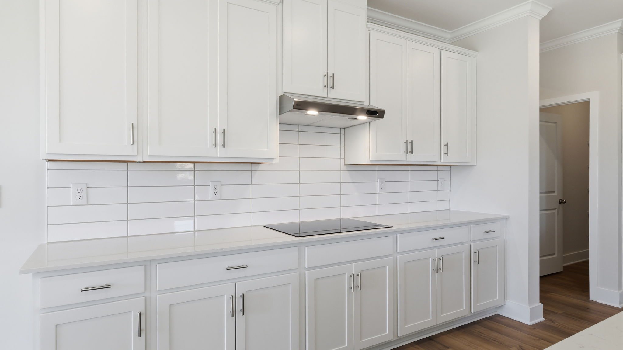 A kitchen with white cabinets.