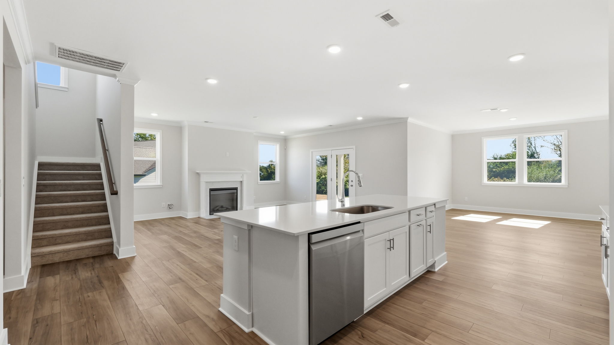 A kitchen with a wood floor.