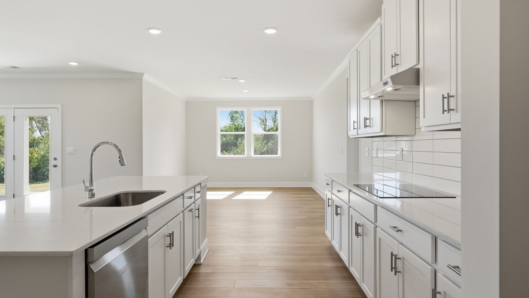 A kitchen with white cabinets.
