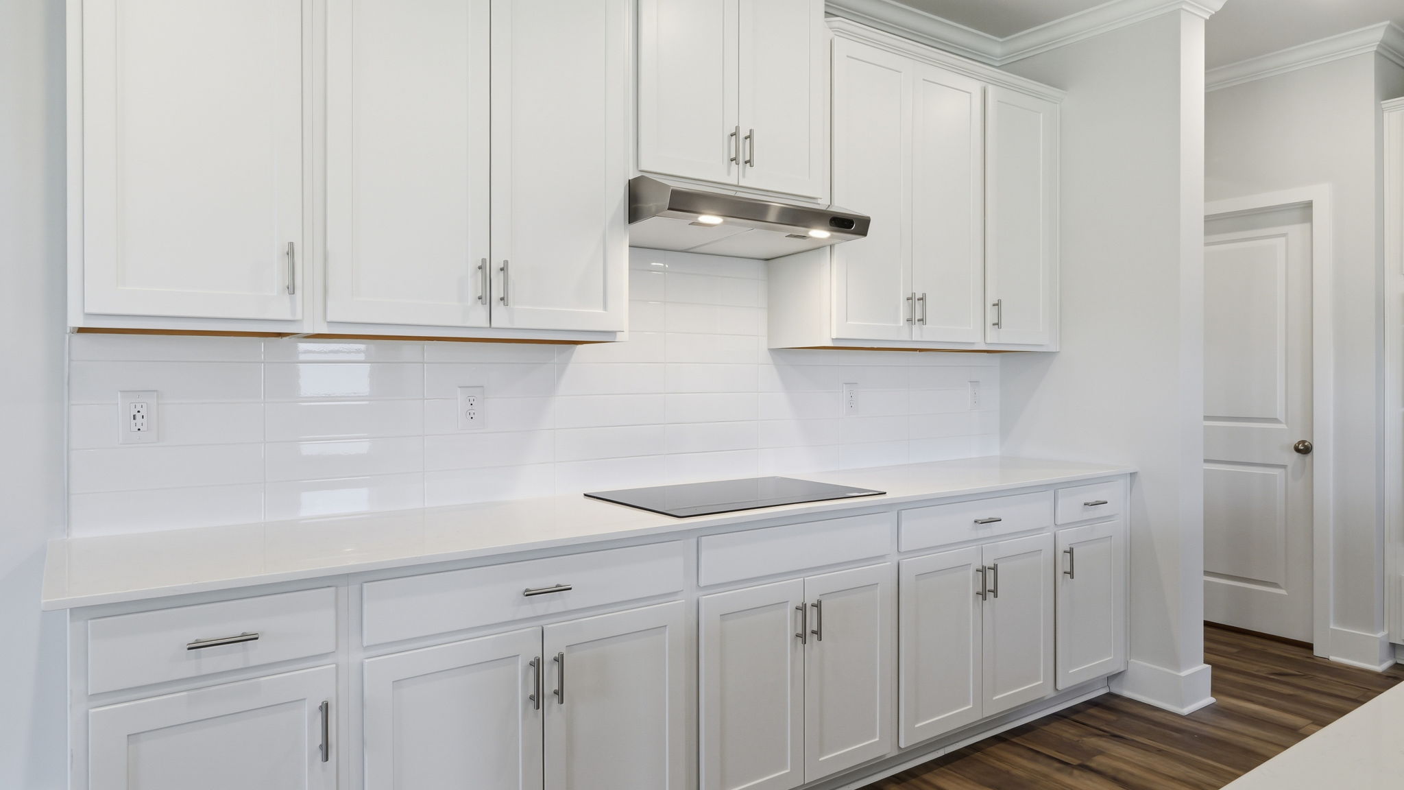 A kitchen with white cabinets.