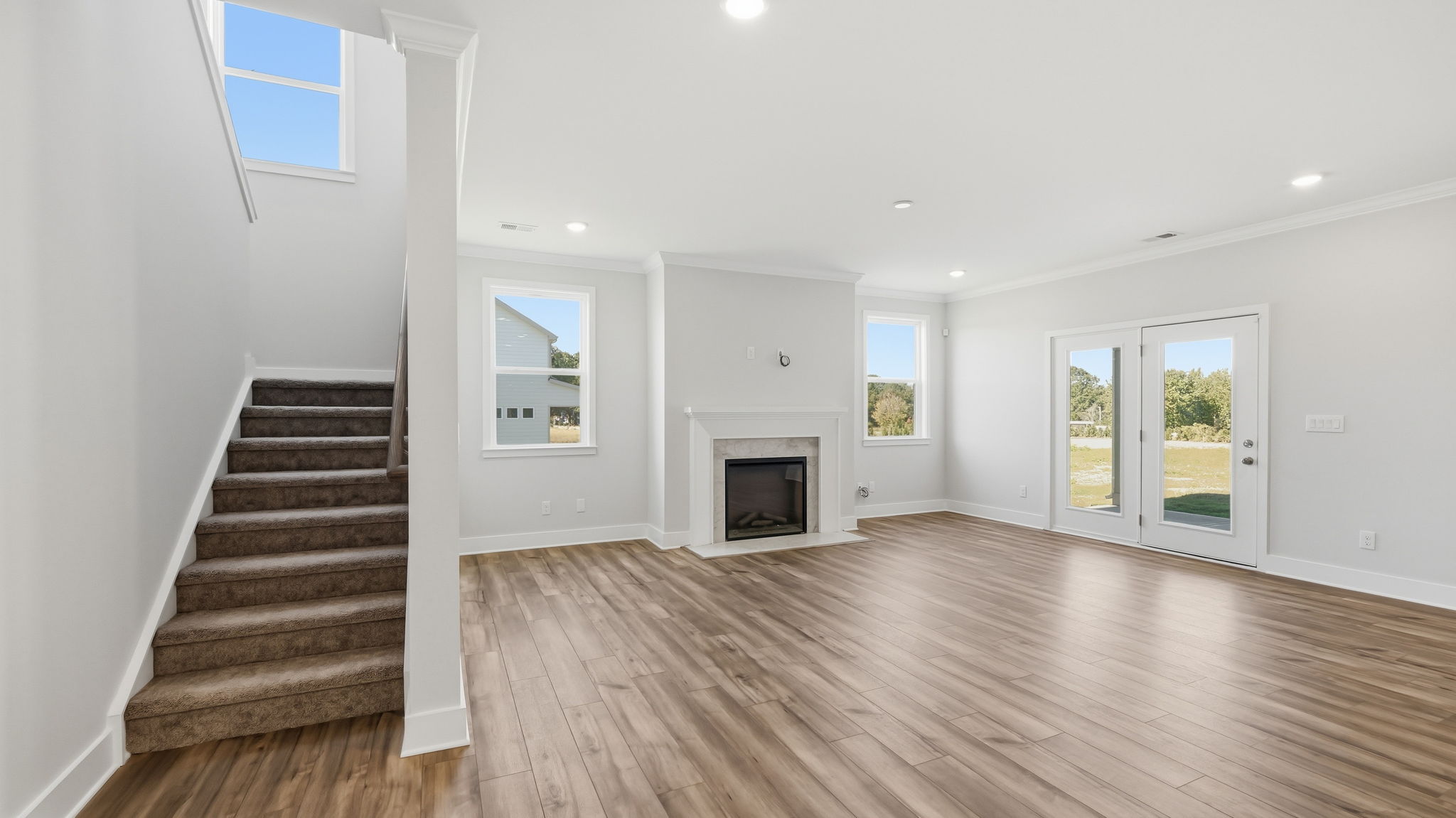 A large empty room with a fireplace.