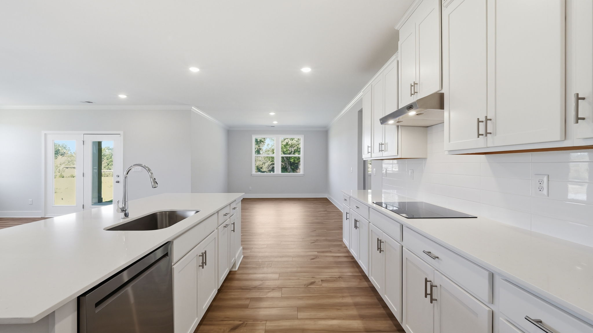 A kitchen with white cabinets.