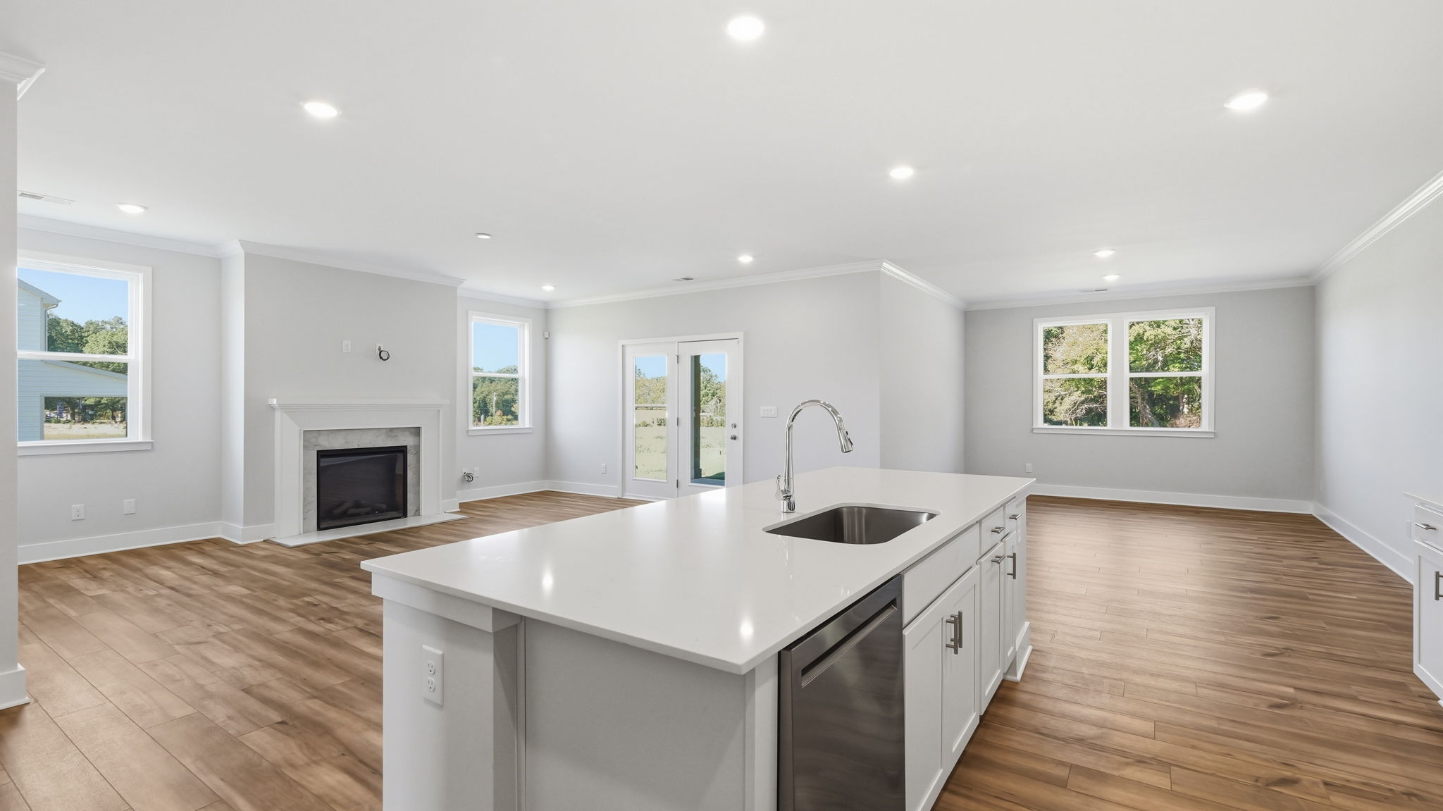 A kitchen with white cabinets.