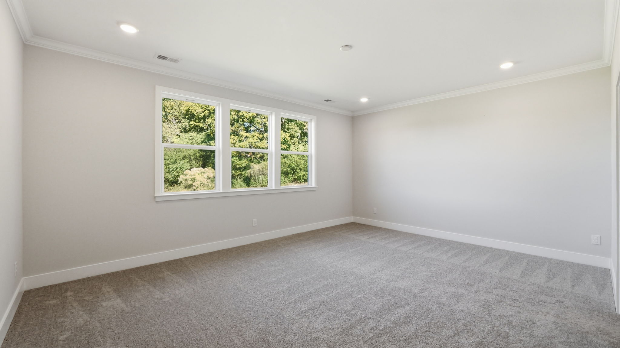 A room with a window and a carpet.
