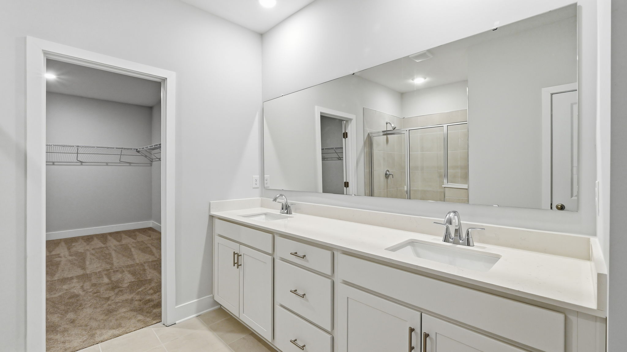 A bathroom with a large mirror.