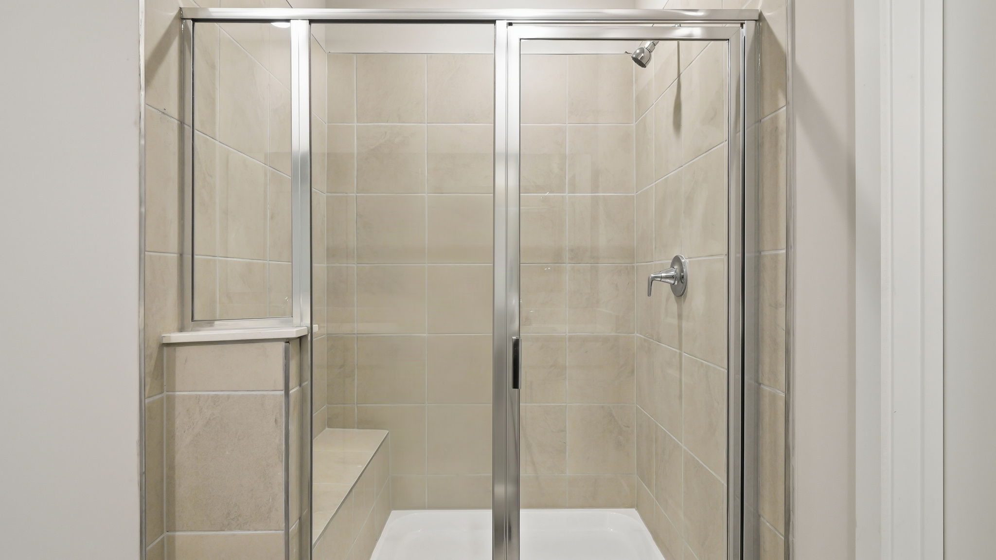 A shower with a glass door.