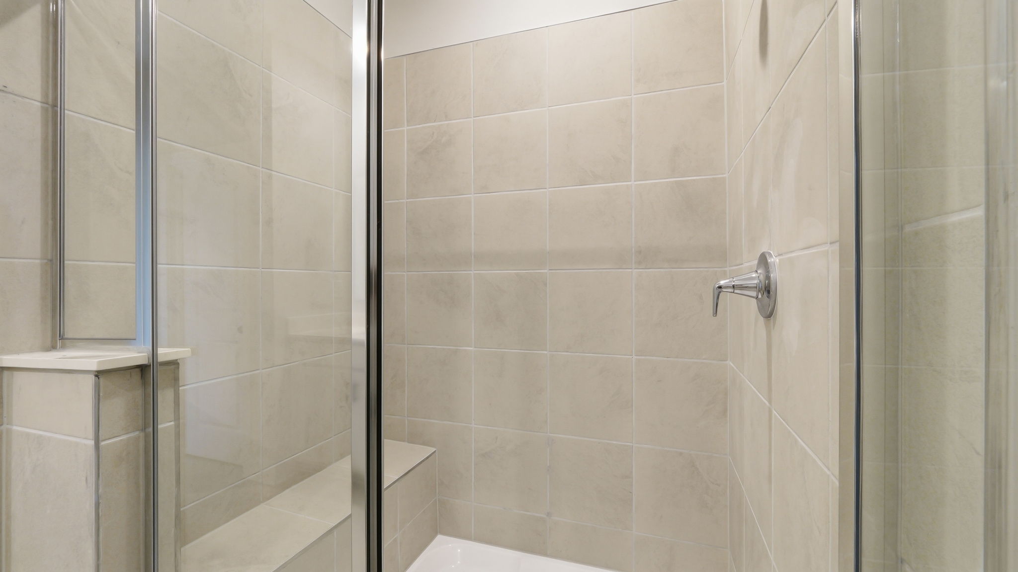 A shower with glass doors.