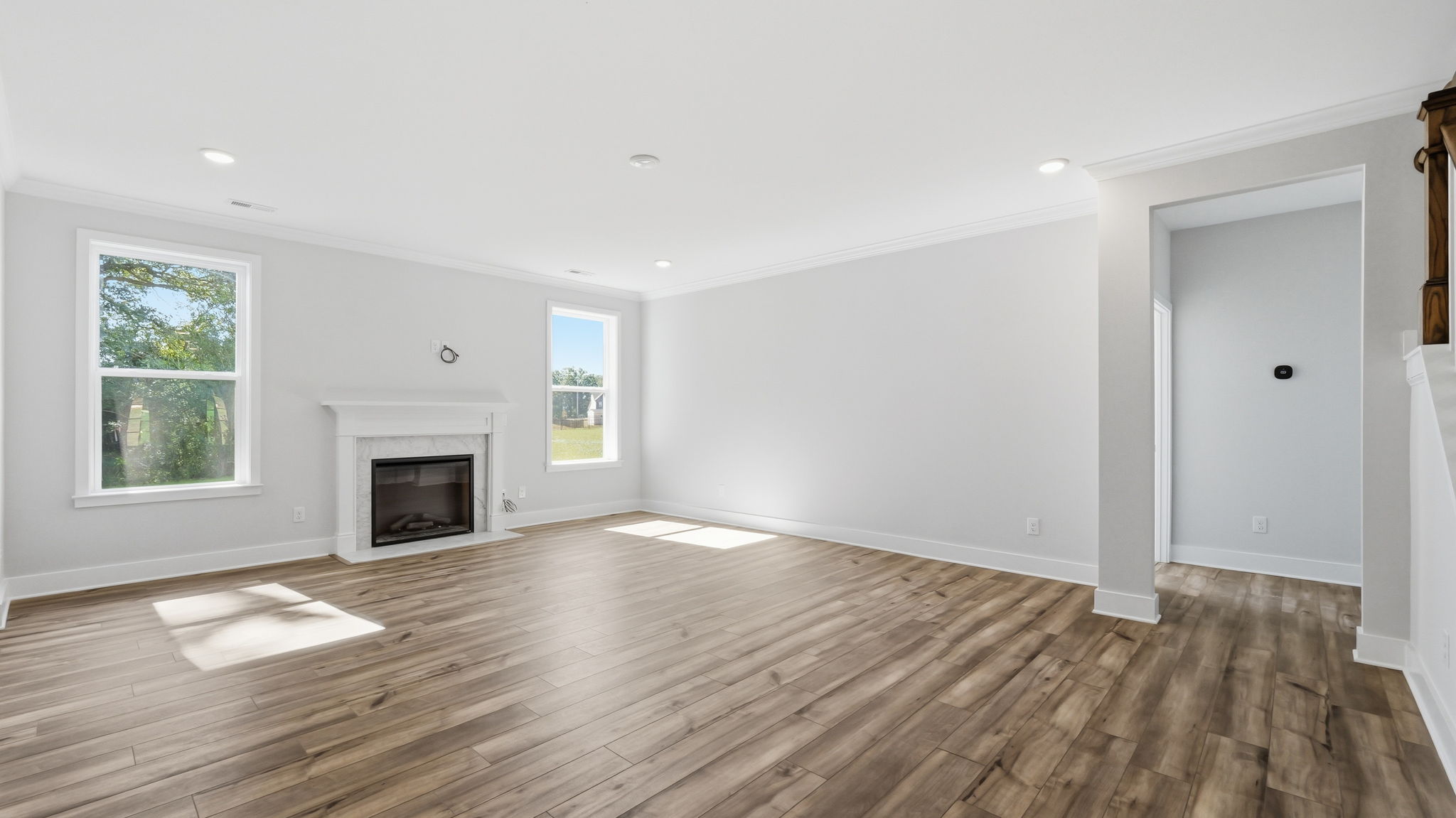A room with a fireplace and wood floors.