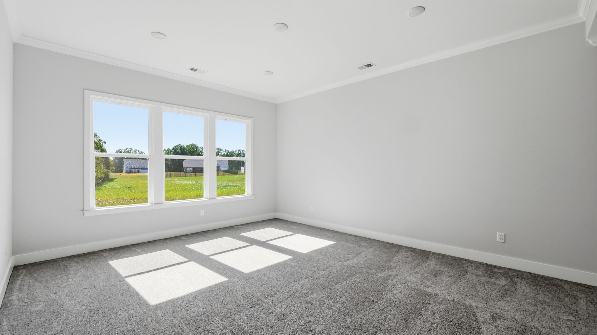 A room with a window and a tile floor.