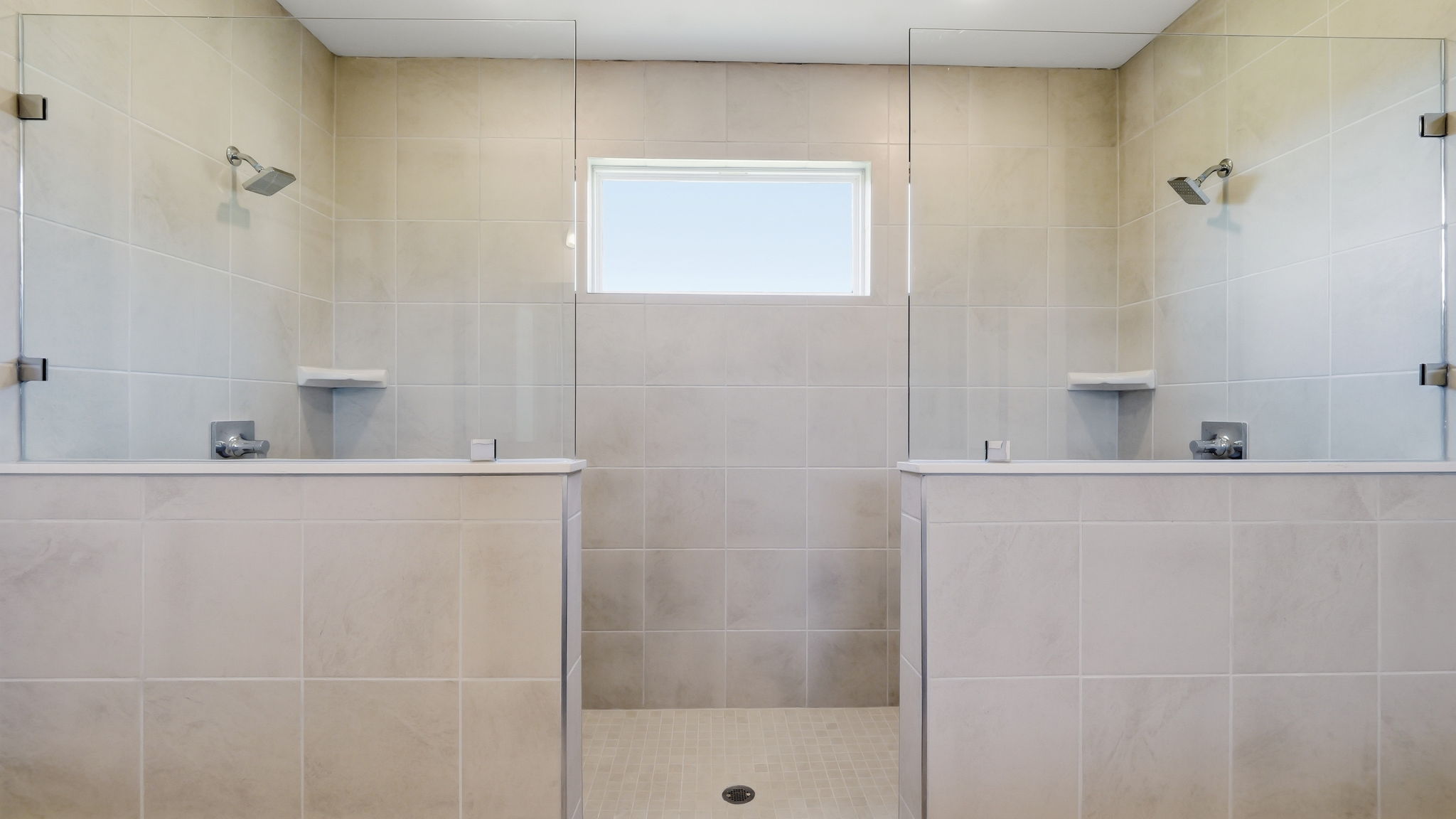 A bathroom with a shower unit.