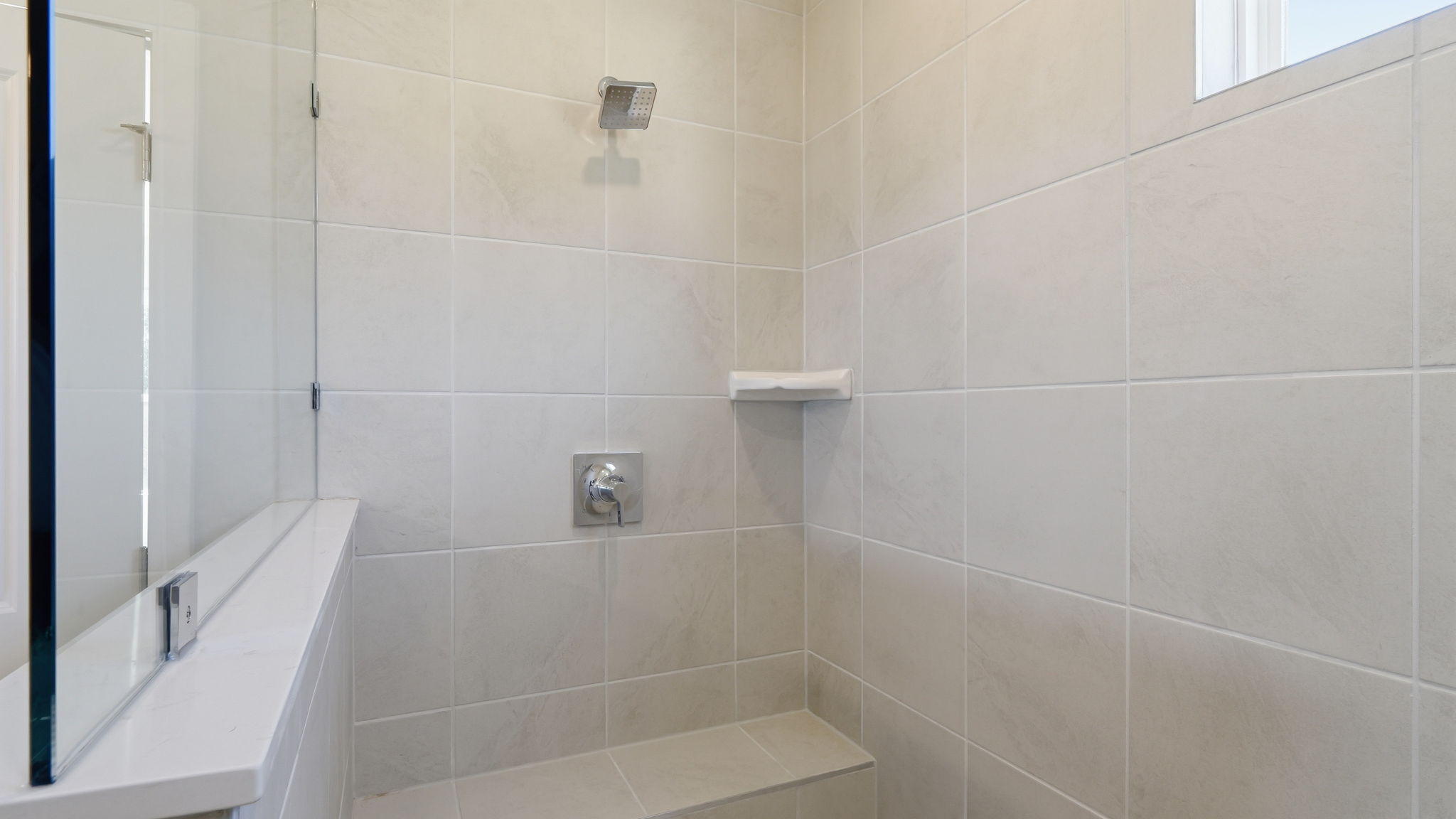 A white tiled bathroom.