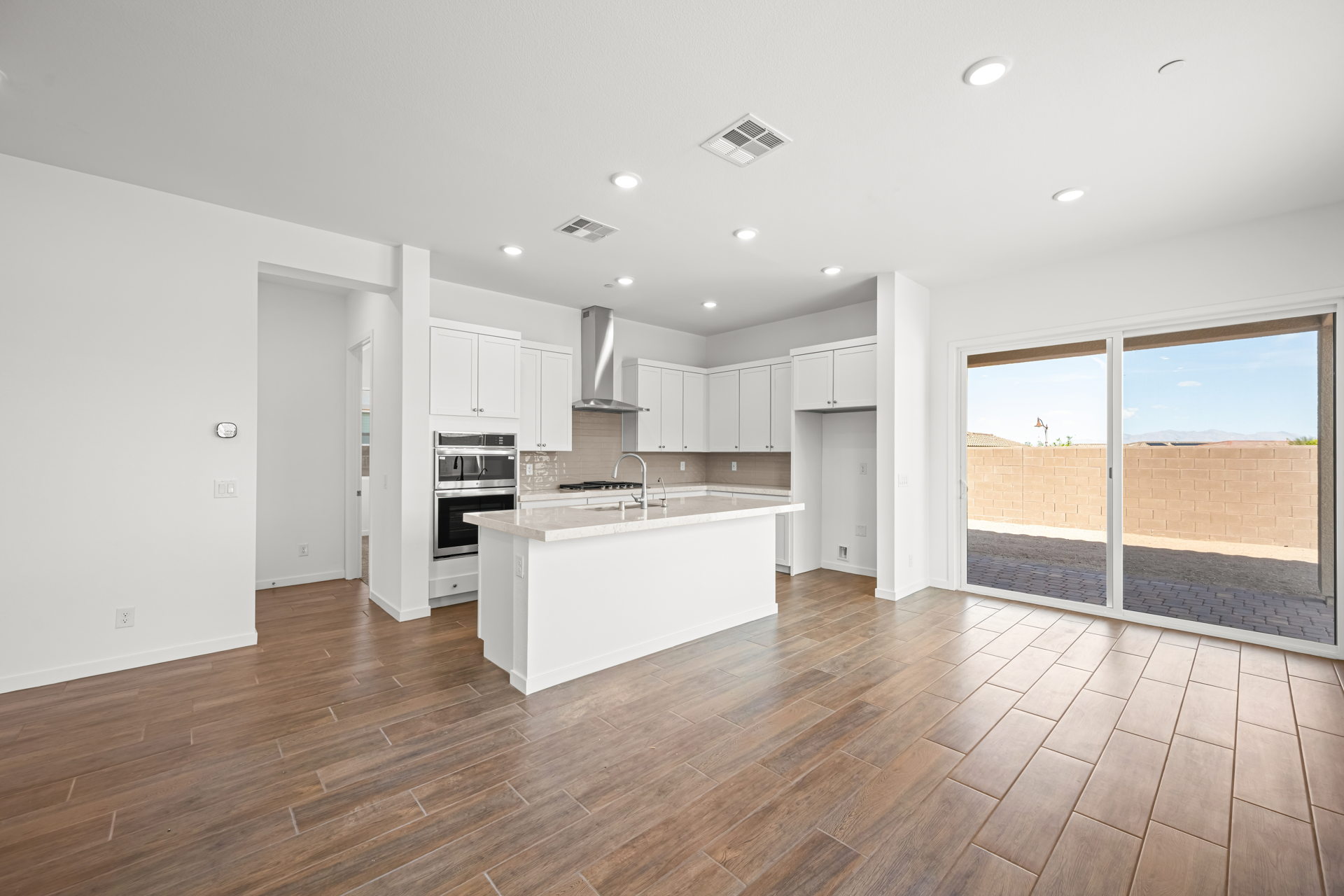 A kitchen with white cabinets.