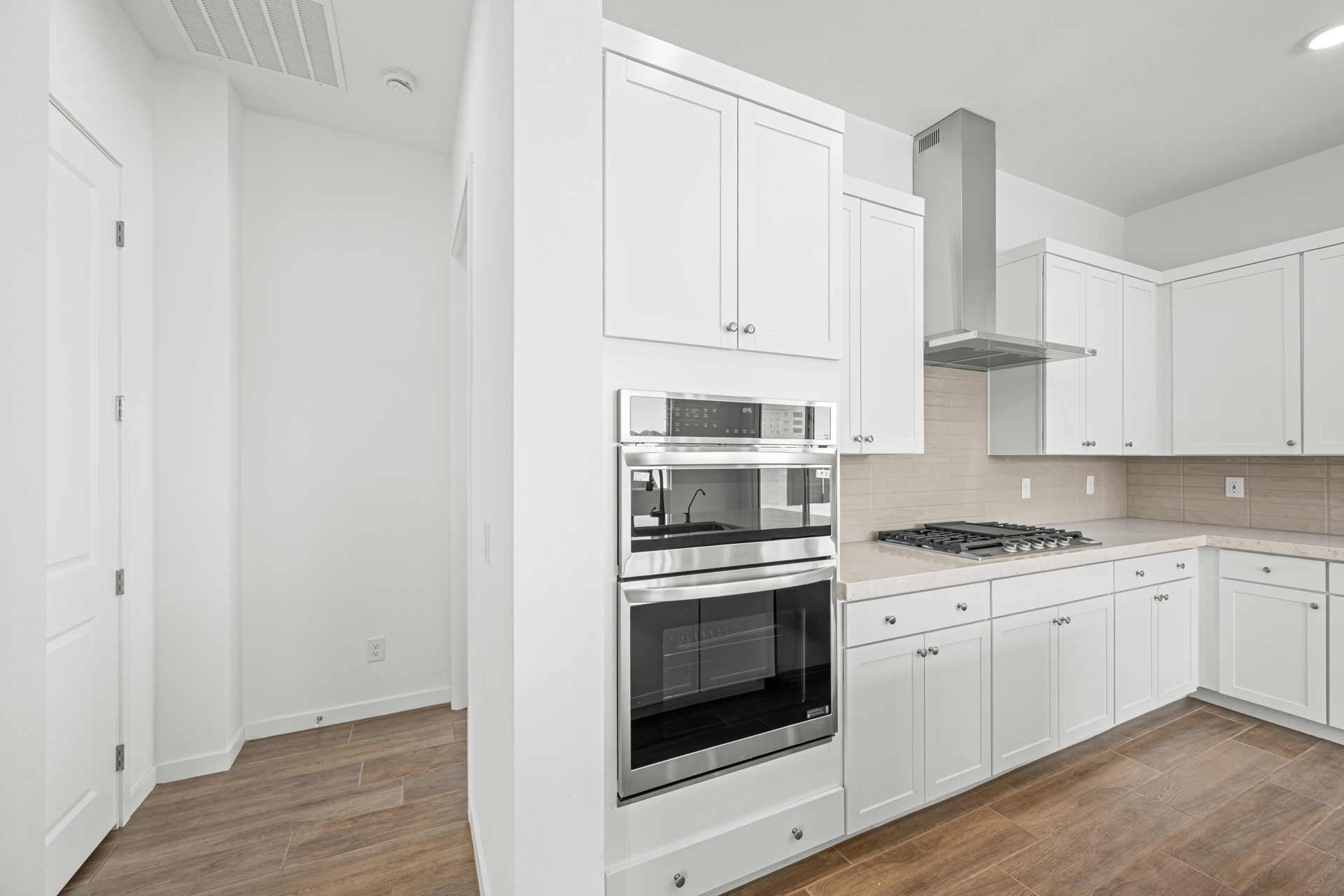 A kitchen with white cabinets.