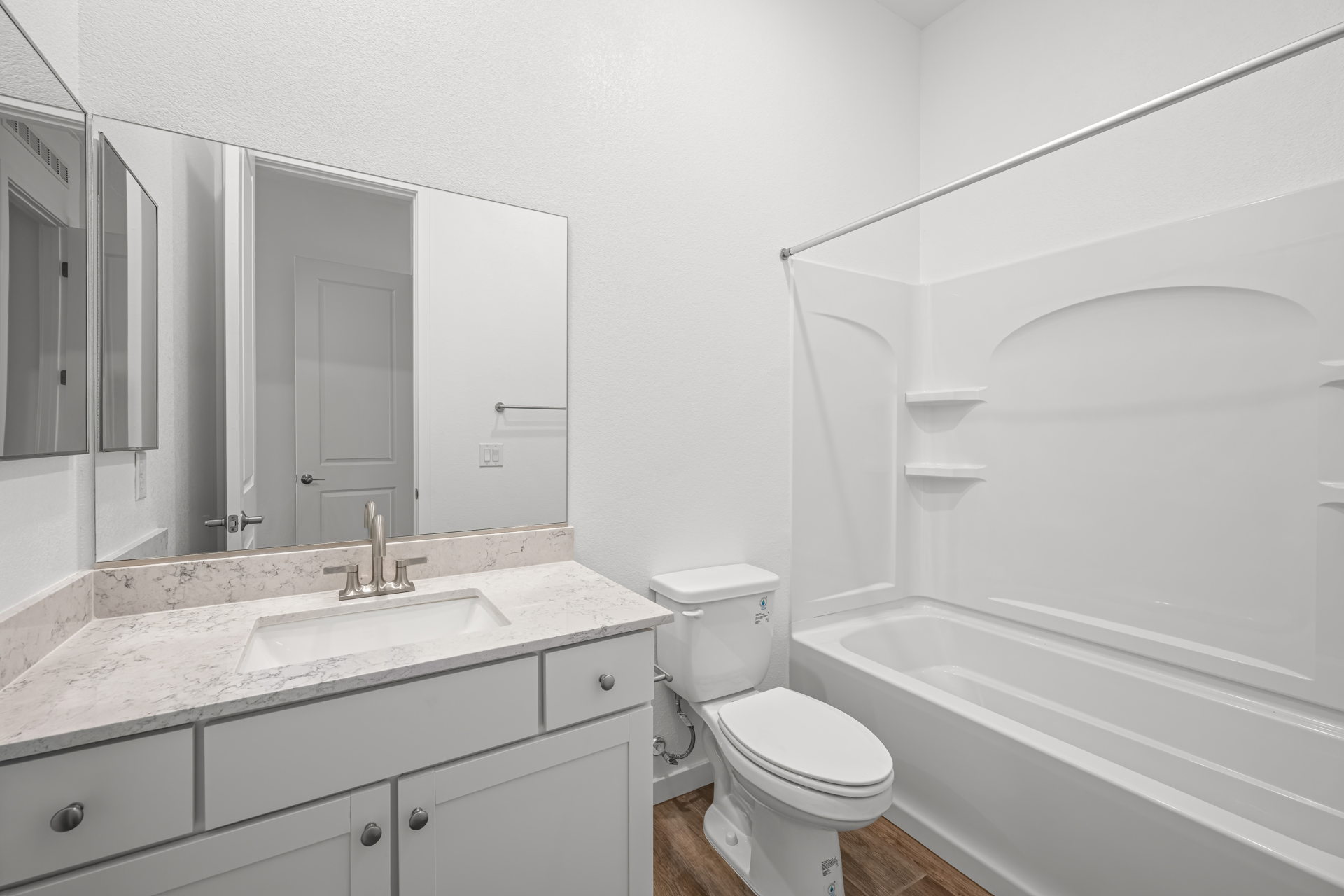 A bathroom with a tub sink and toilet.