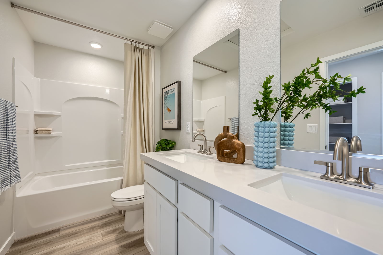 A bathroom with a tub sink and toilet.
