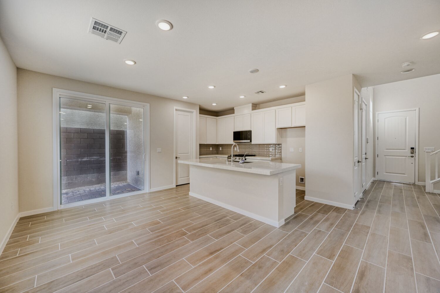 A large kitchen with white cabinets.