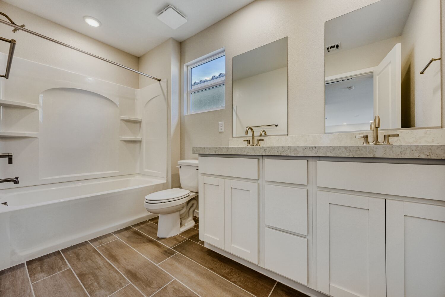 A bathroom with a tub toilet and sink.