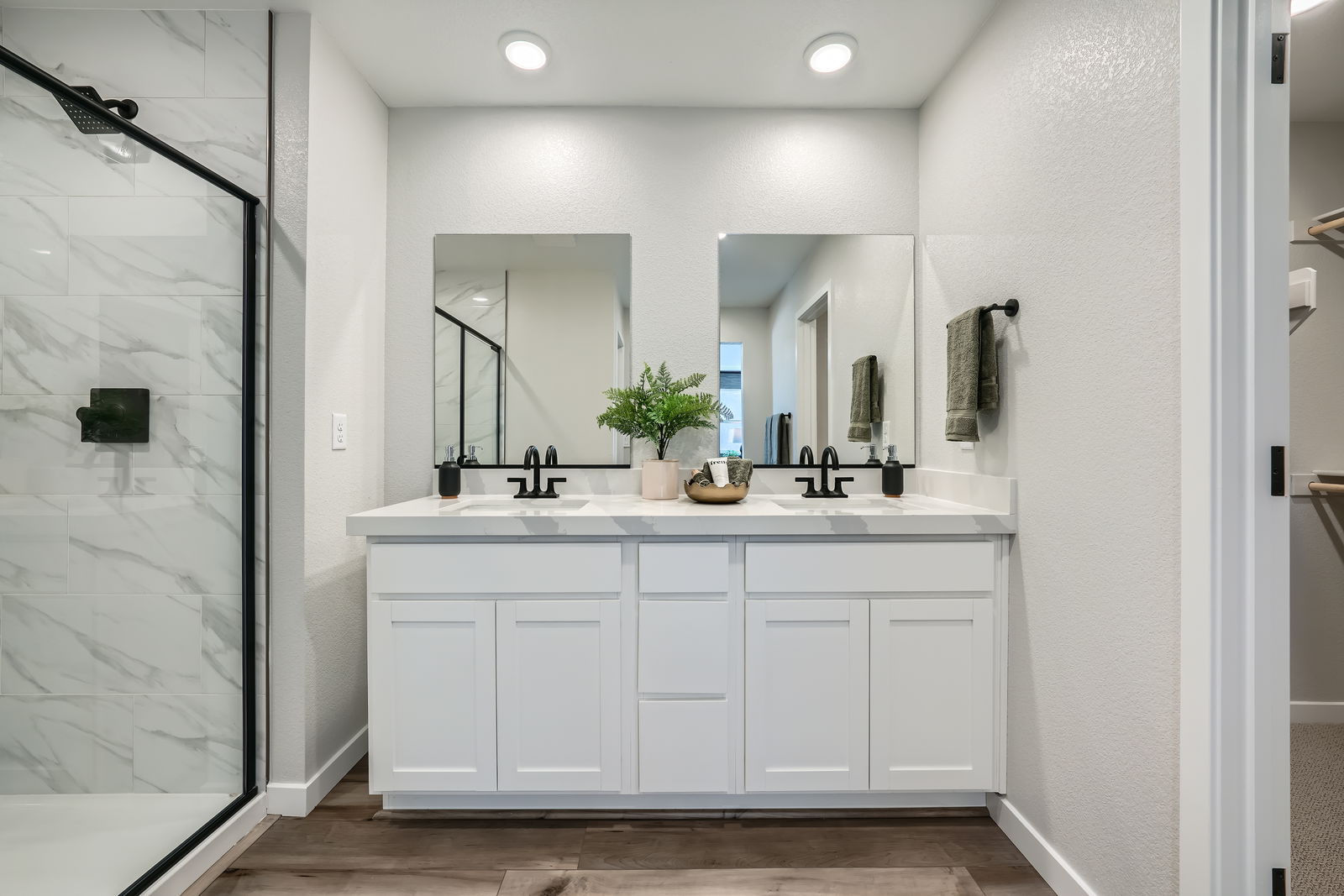 A bathroom with white cabinets.