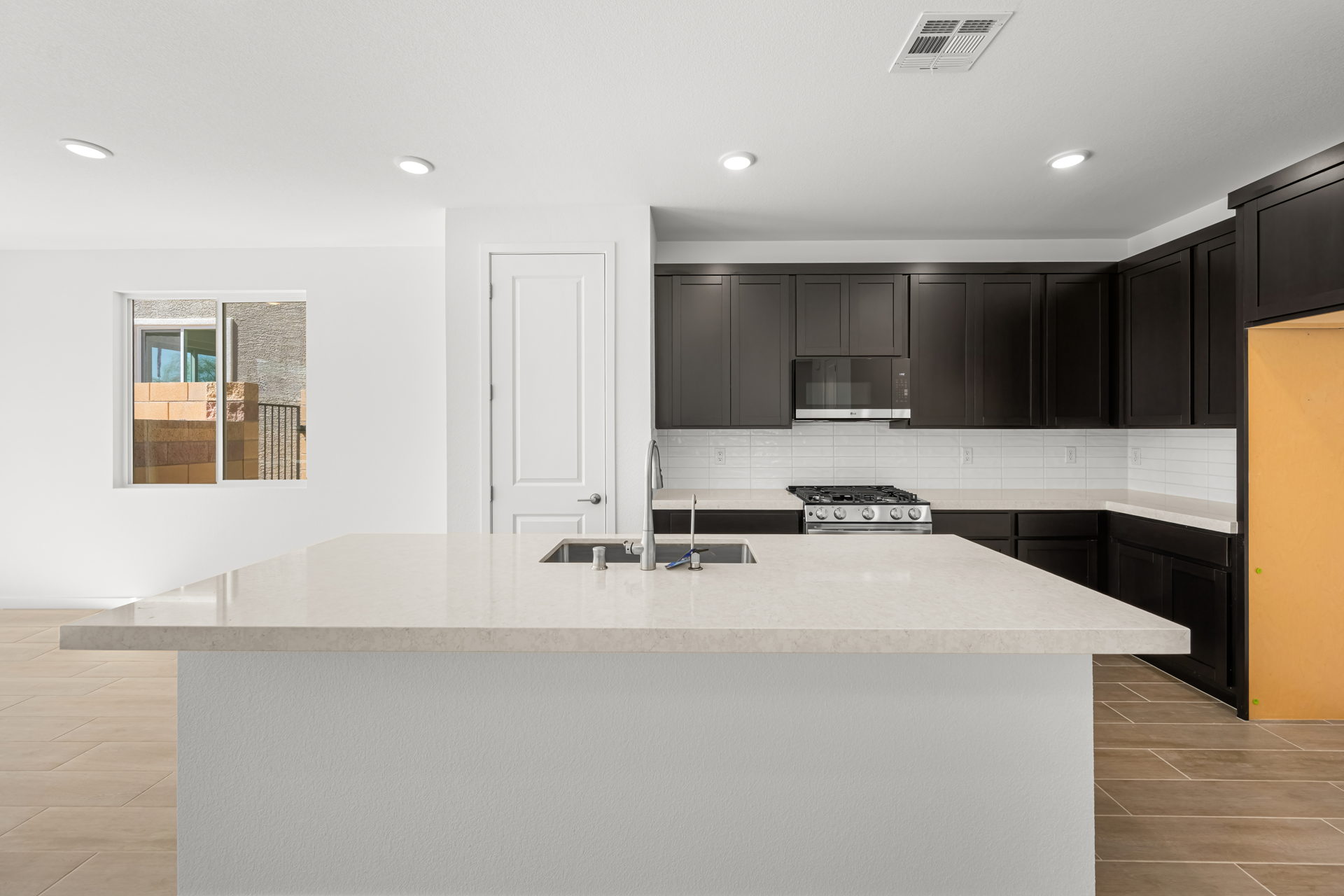 A kitchen with black cabinets.