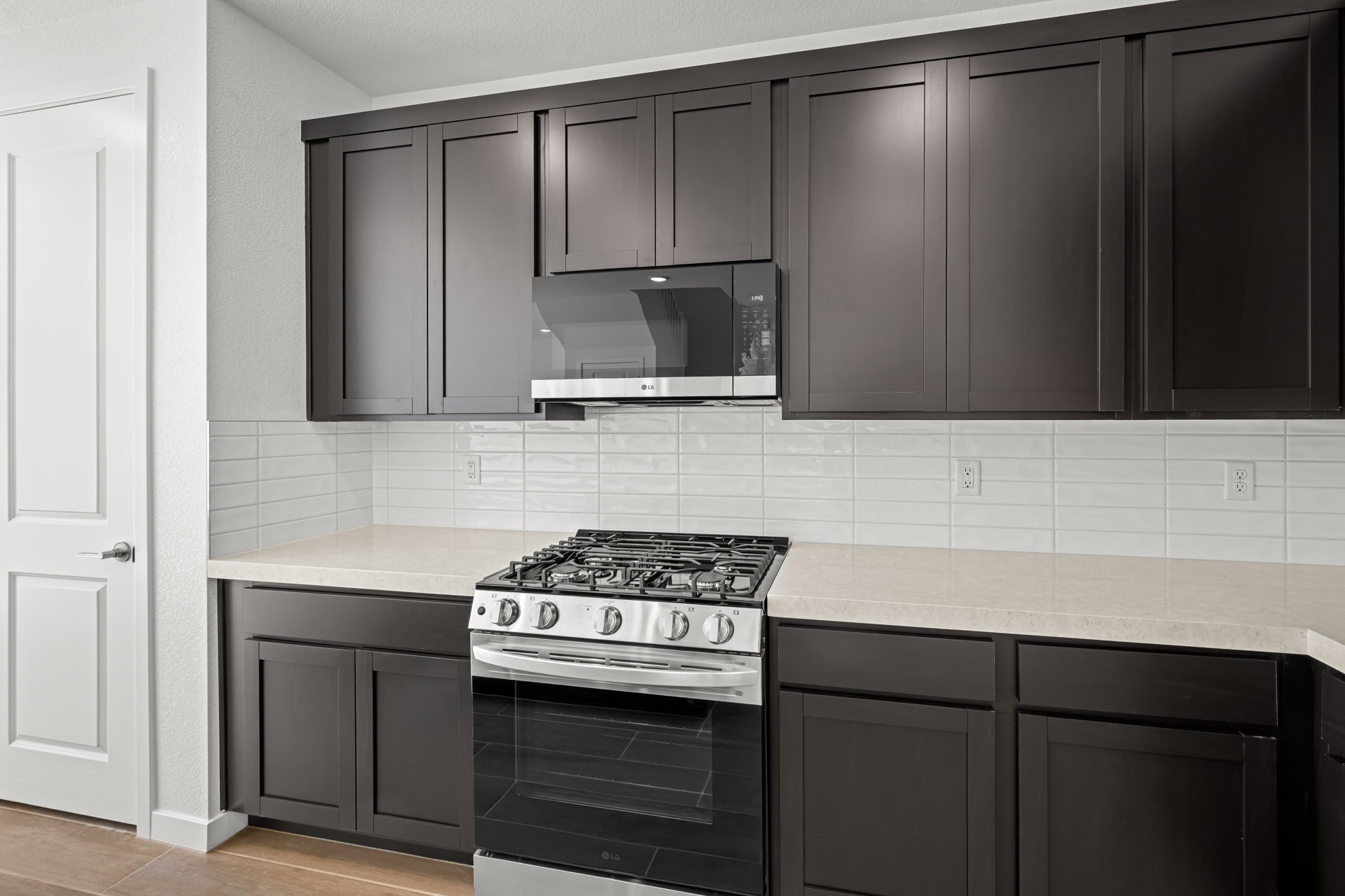 A kitchen with black cabinets.