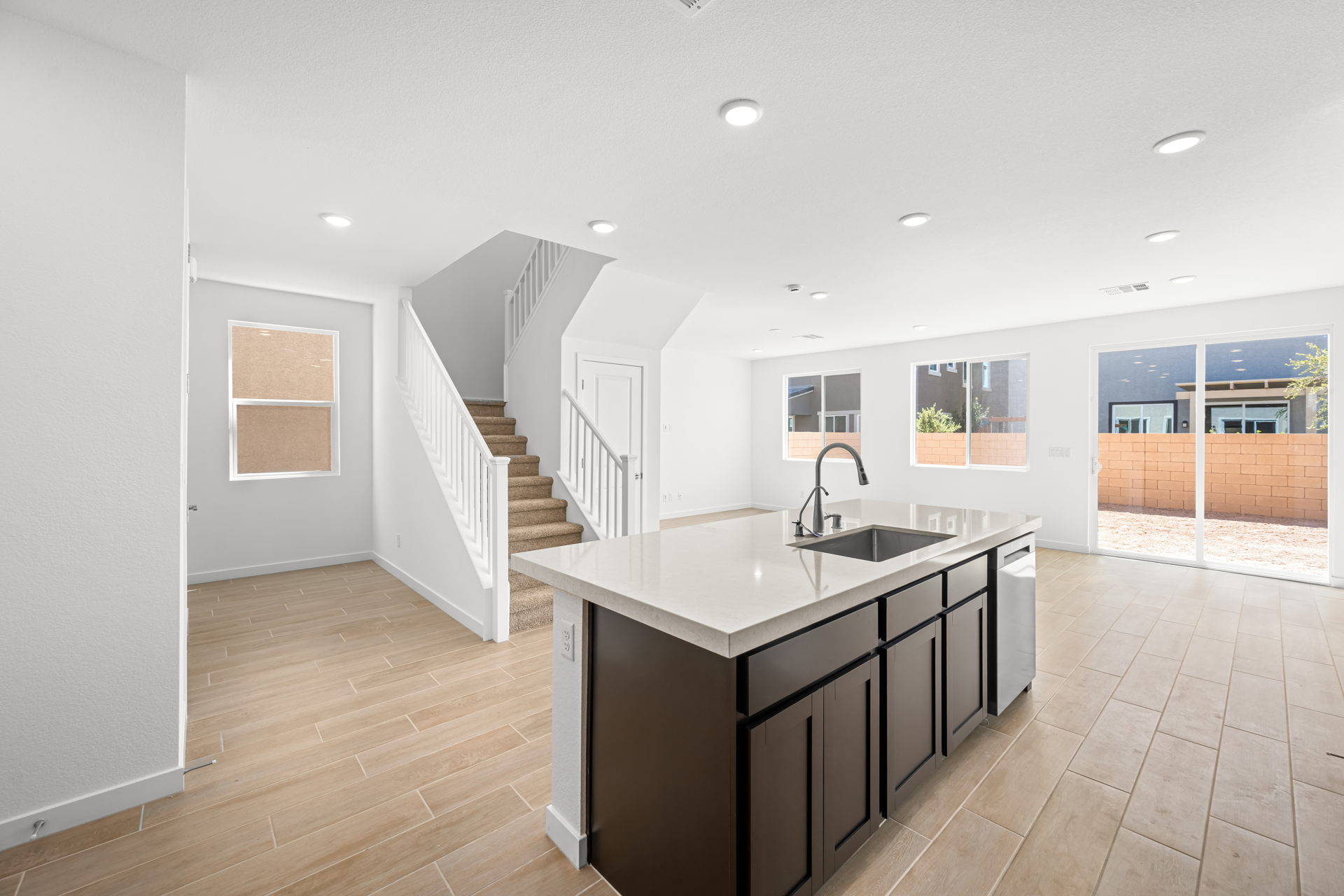 A kitchen with a large staircase.