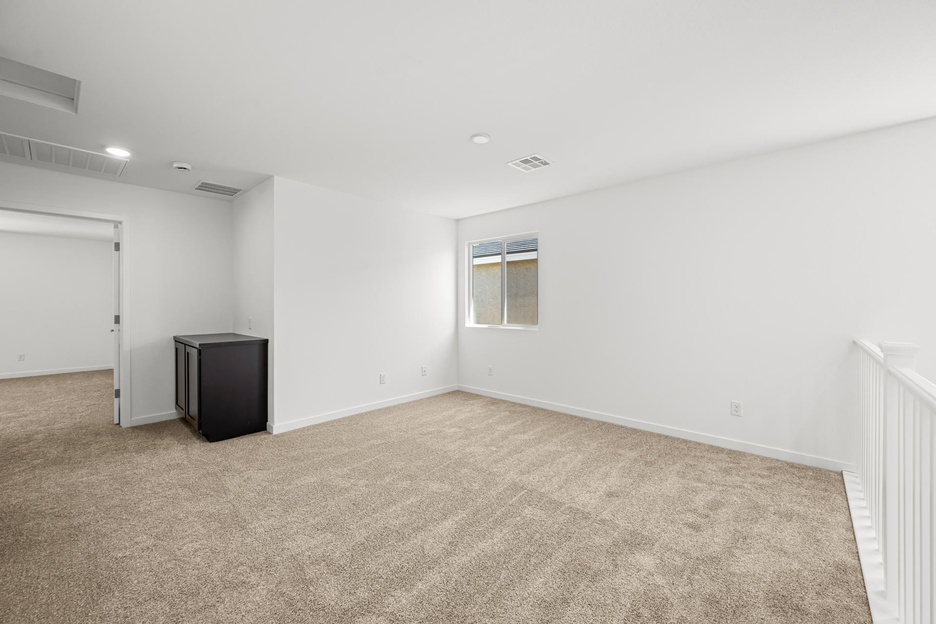 A room with a carpet and a window.