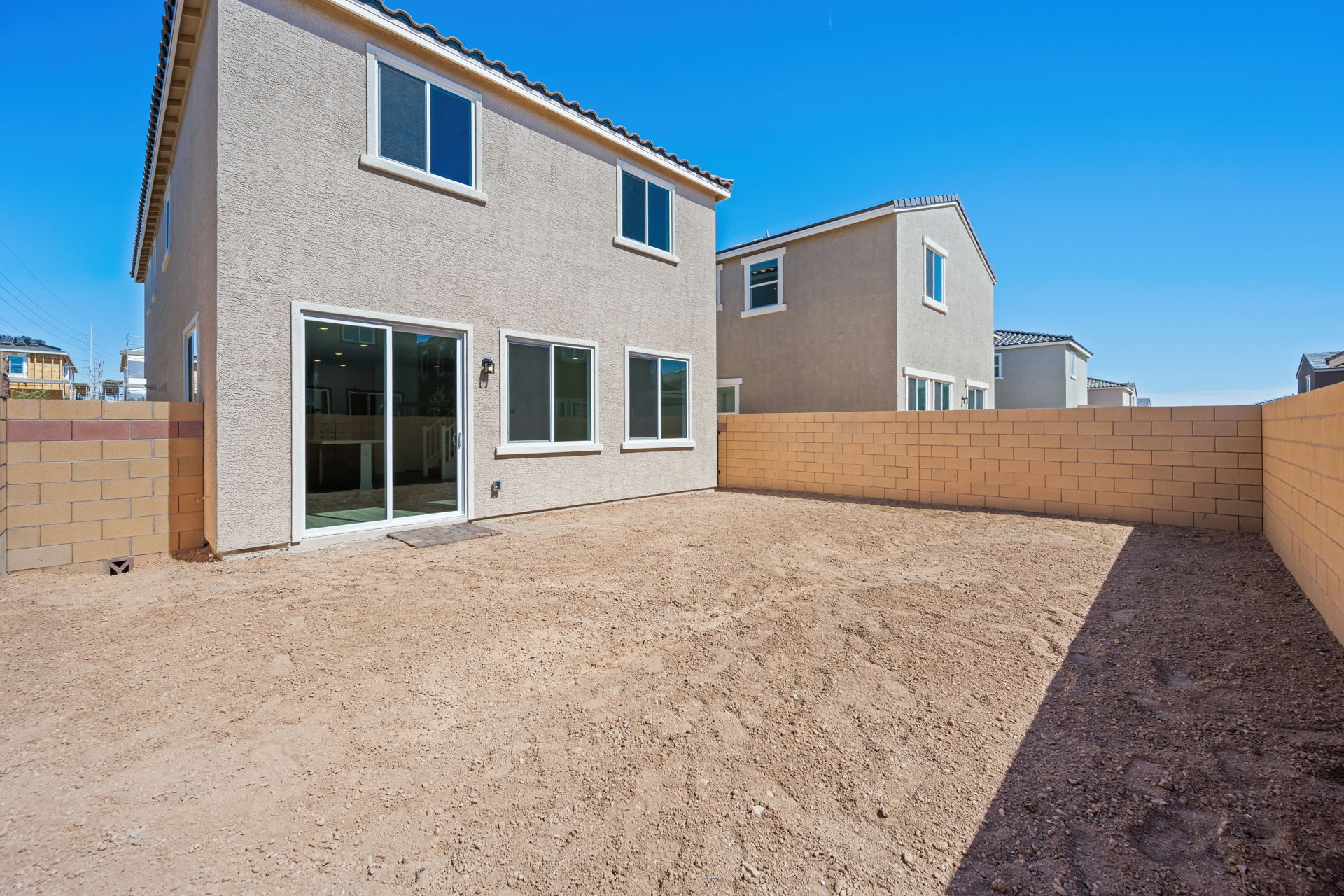 A building with a dirt yard.