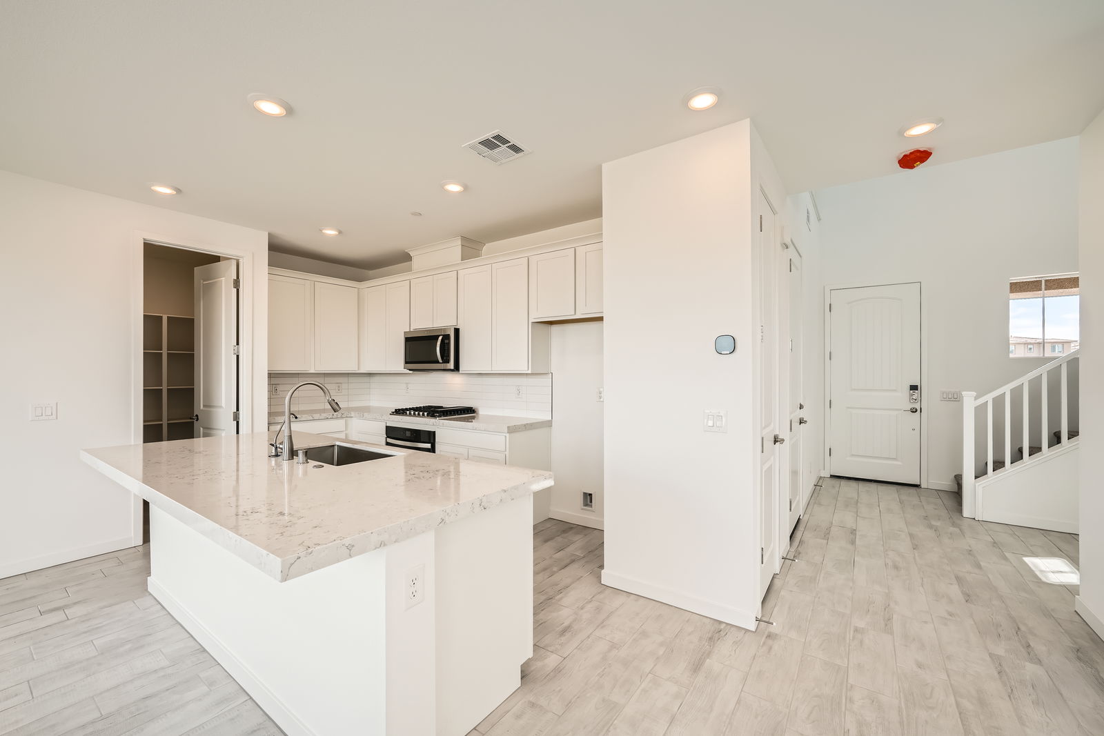 A kitchen with white cabinets.