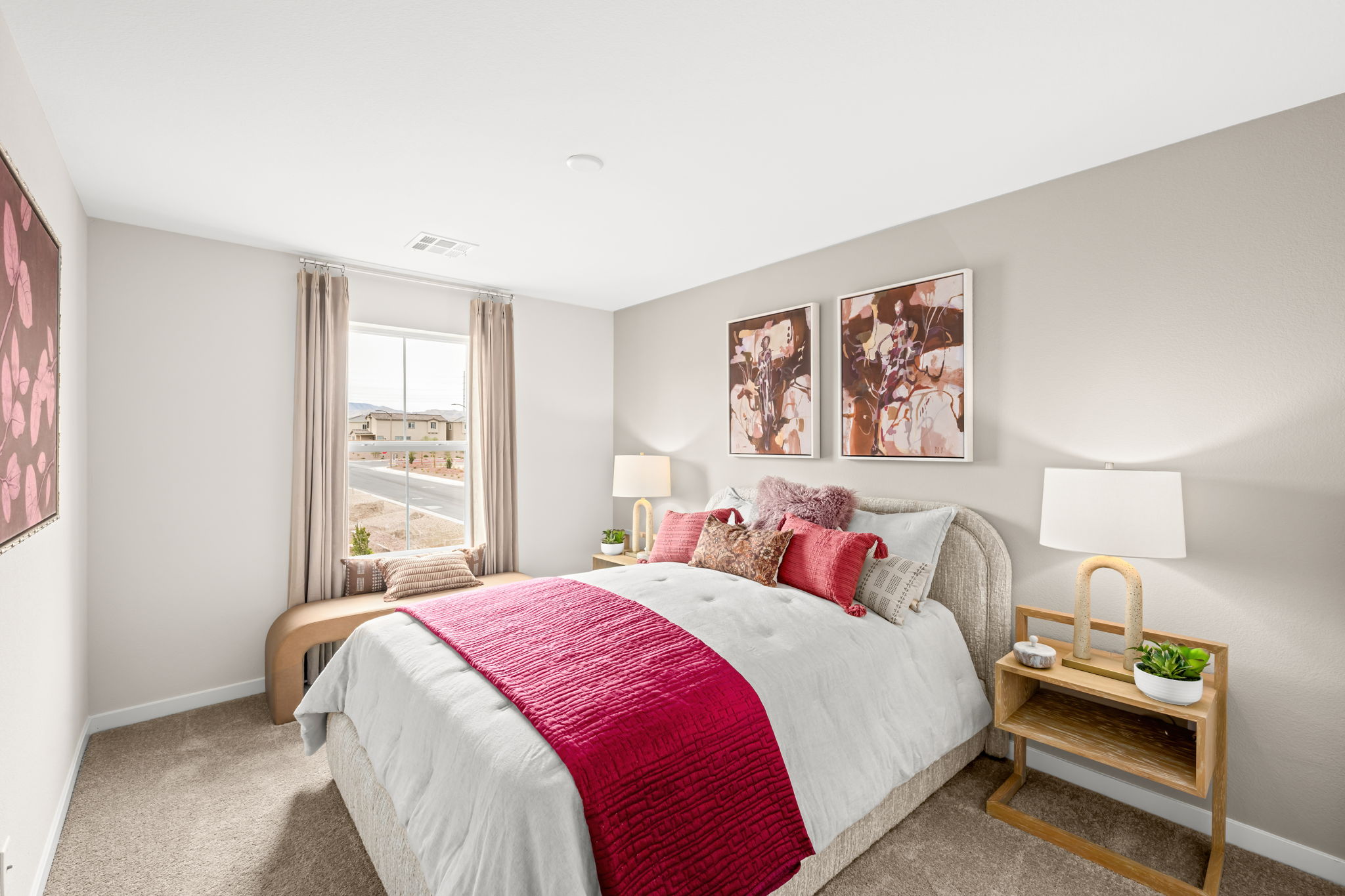 A bedroom with a bed and a table.