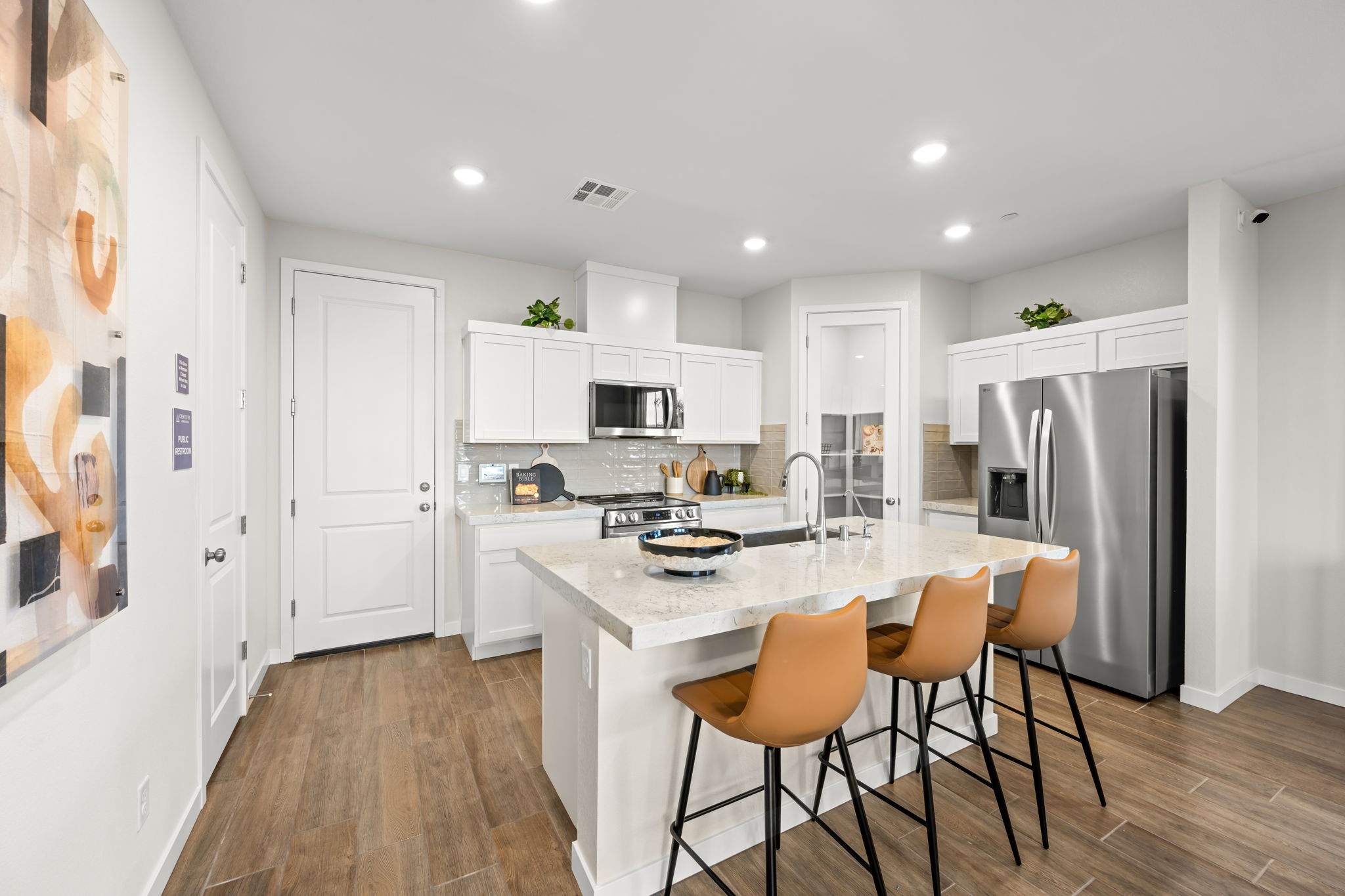 A kitchen with white cabinets.