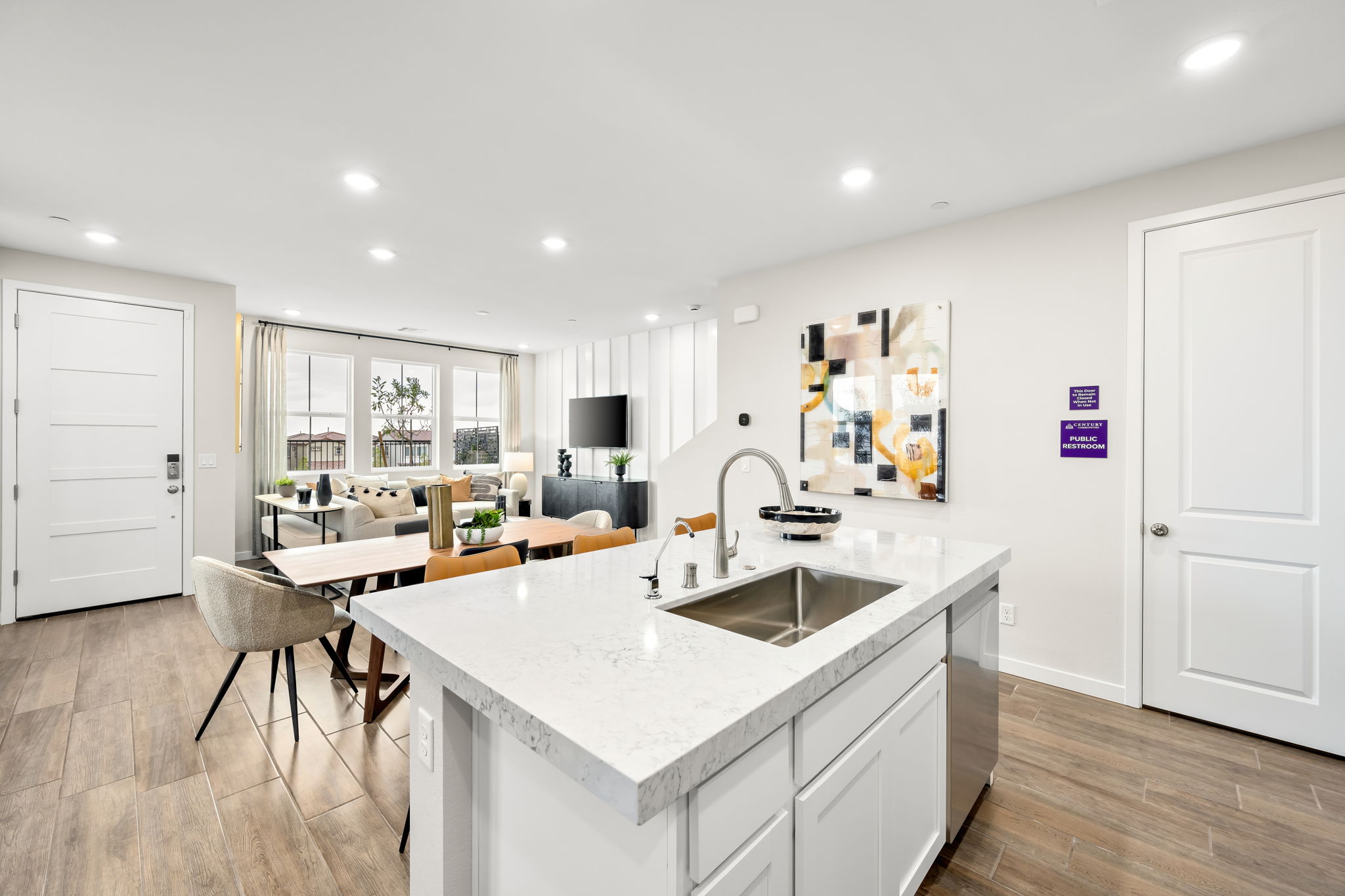 A kitchen with white cabinets.