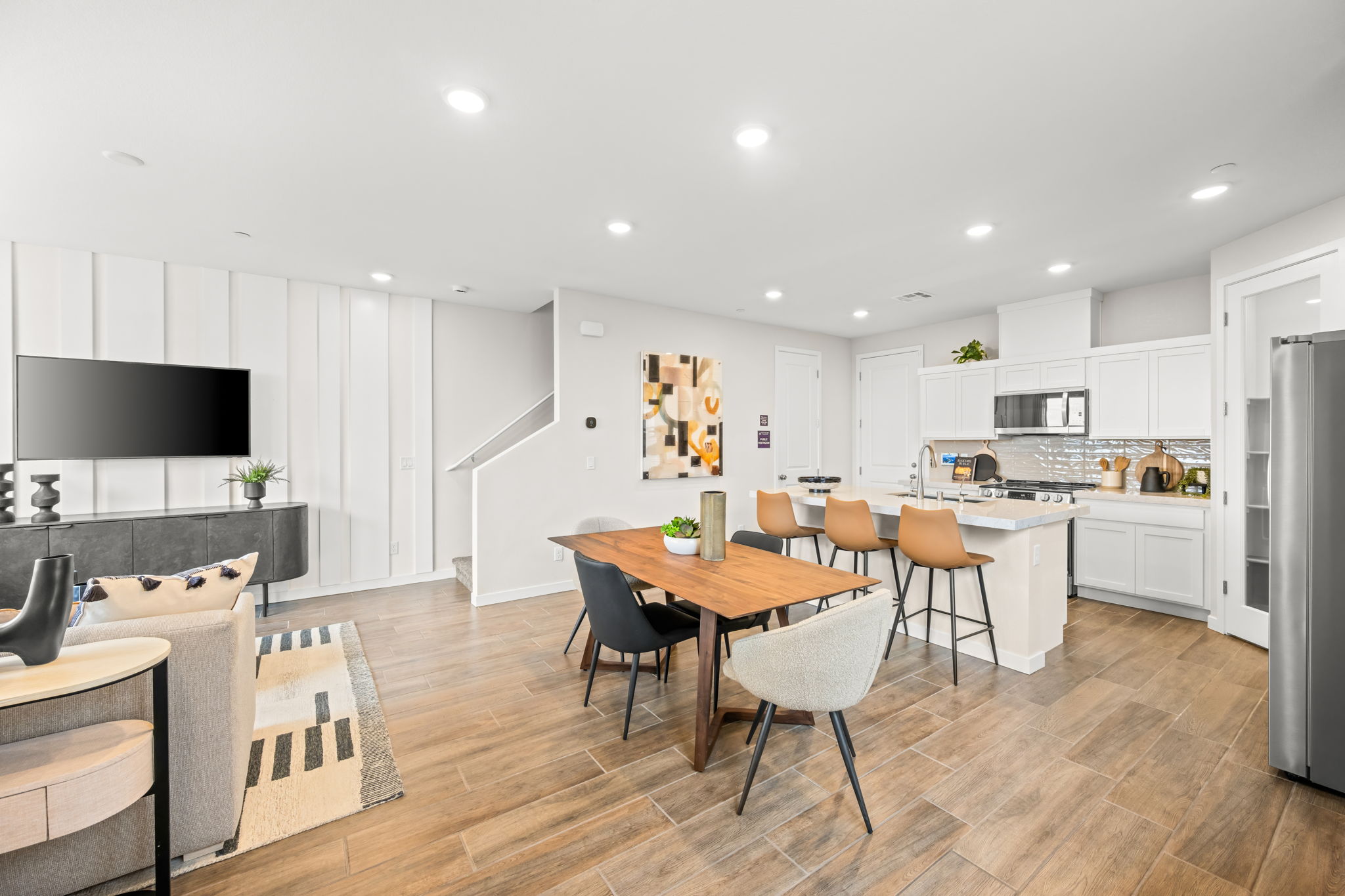 A kitchen with a dining table and chairs.