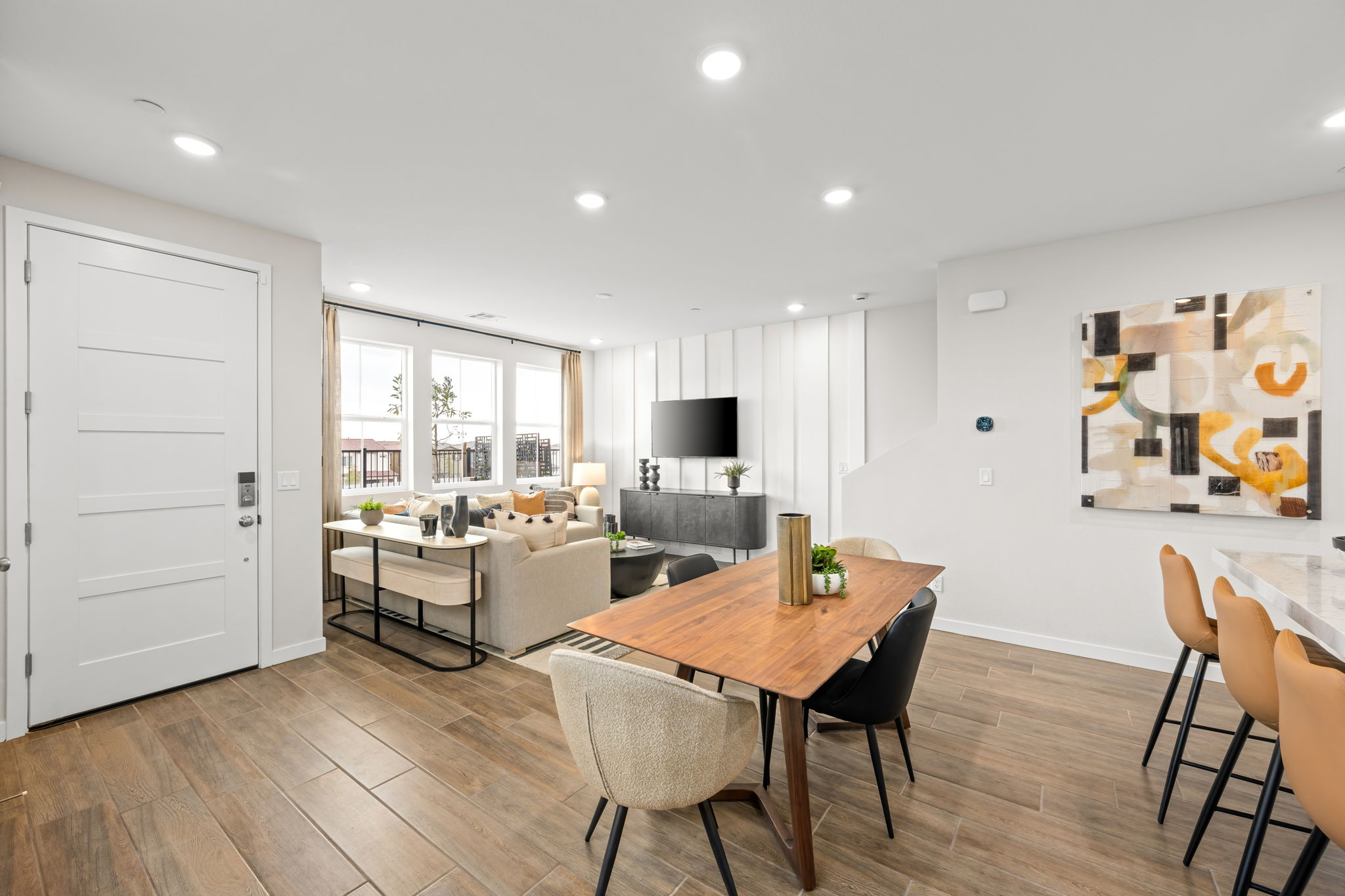 A large living room with a wood floor and a wood floor.