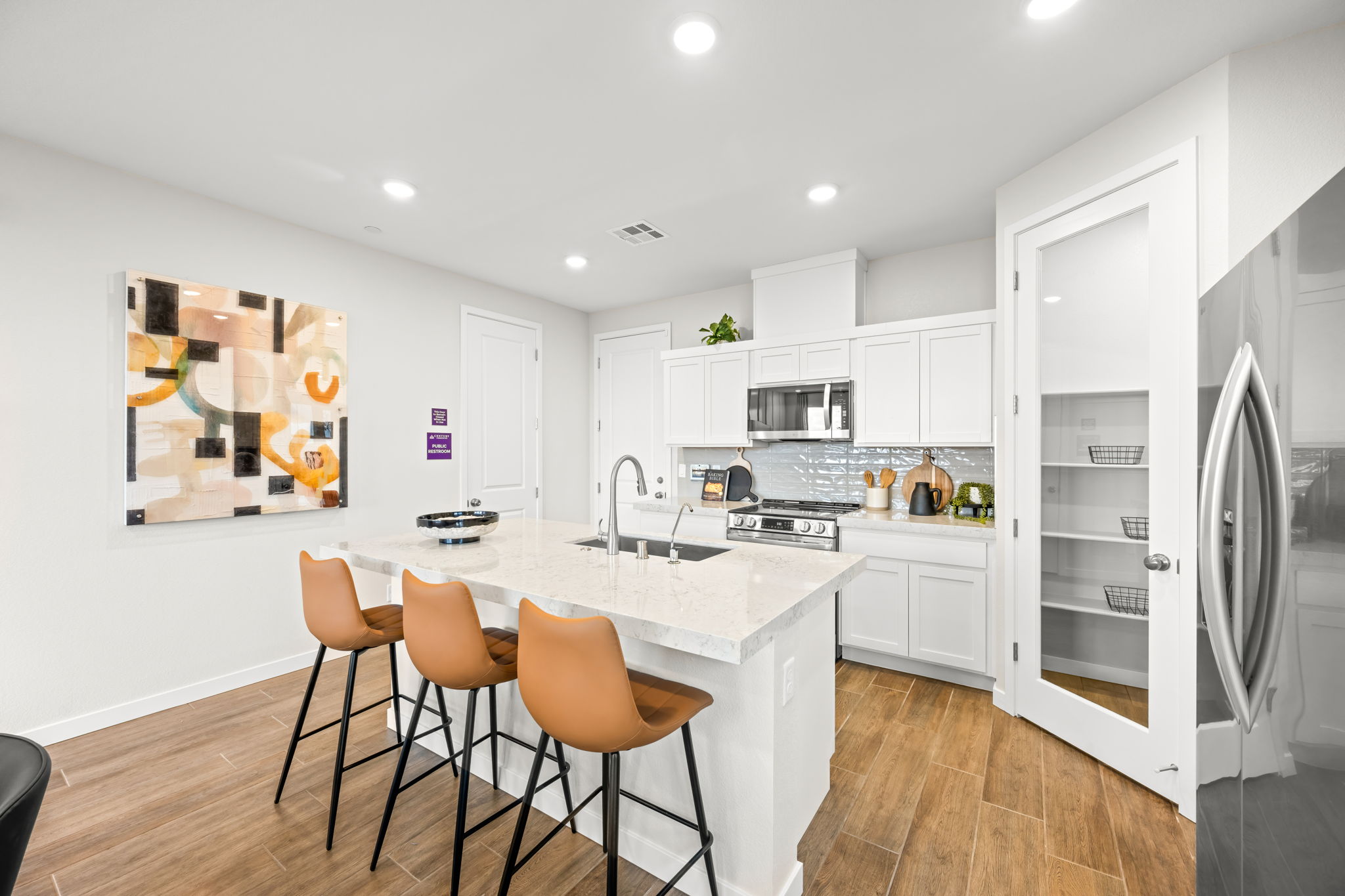 A kitchen with white cabinets.