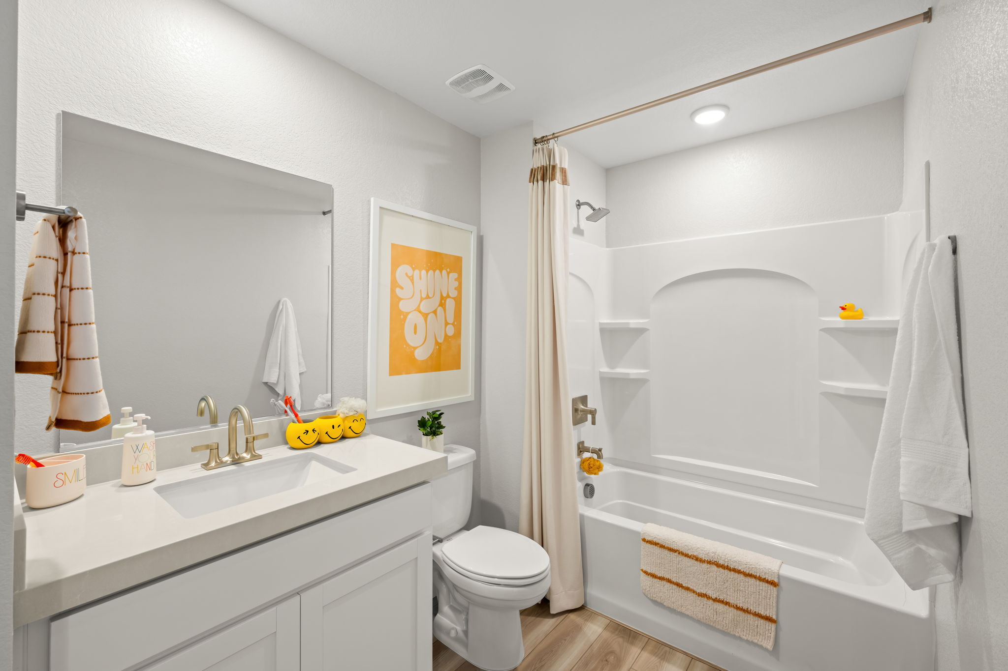 A bathroom with a tub toilet and sink.