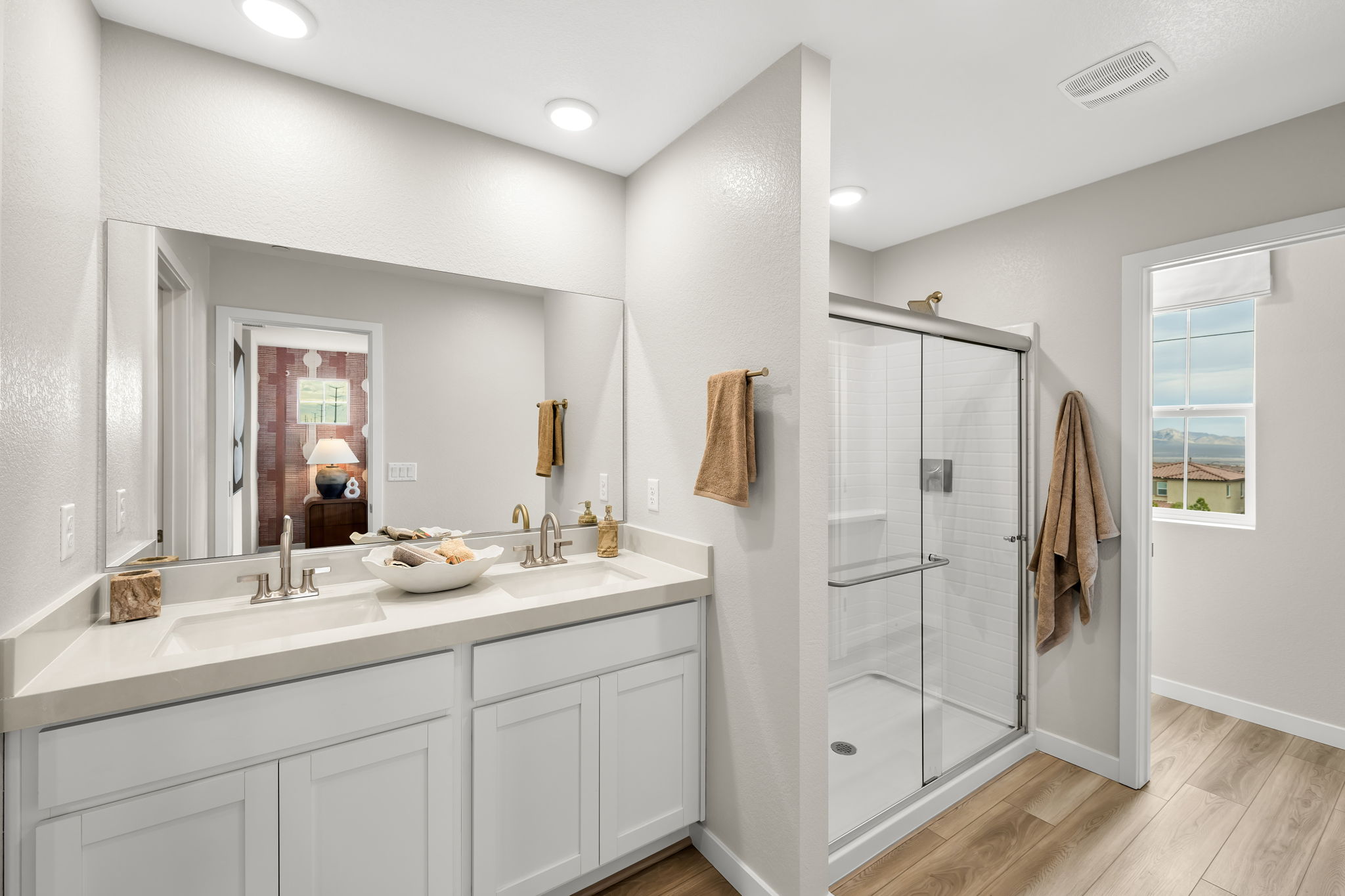 A bathroom with white cabinets.