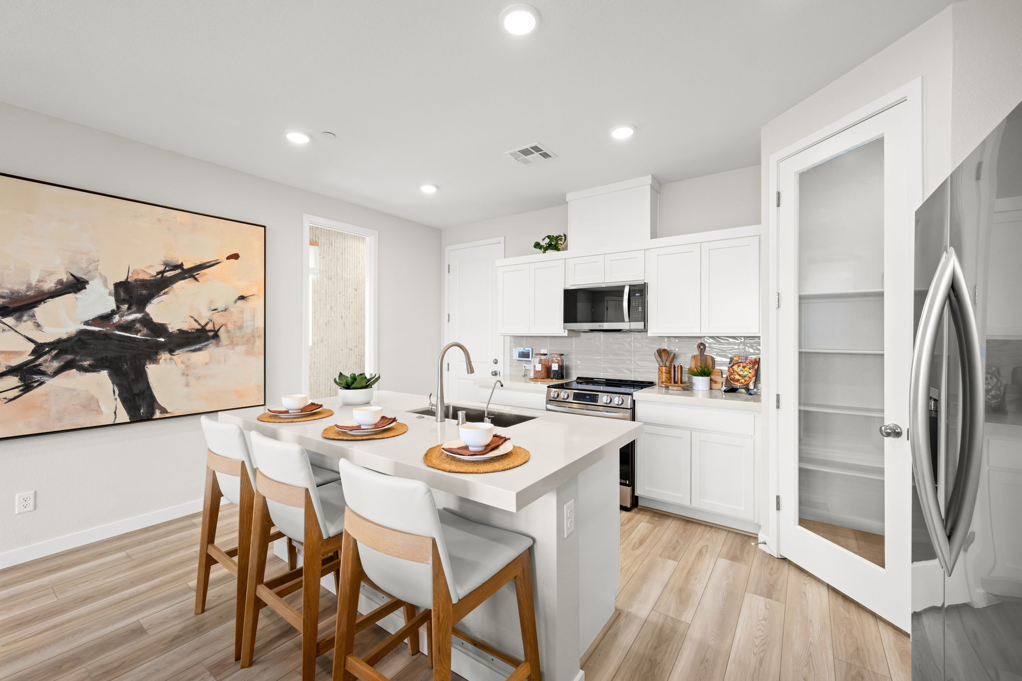 A kitchen with white cabinets.