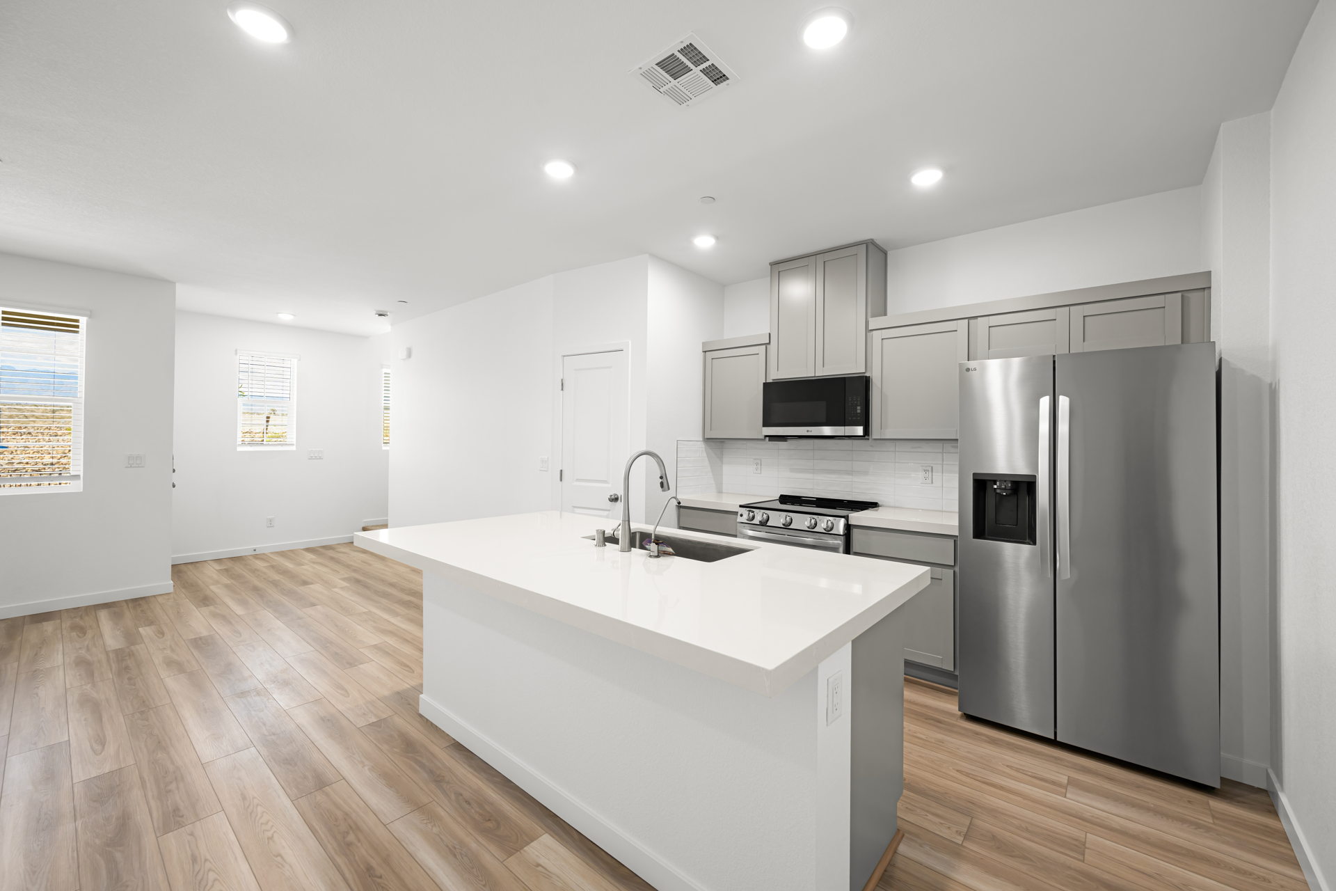 A kitchen with white cabinets.