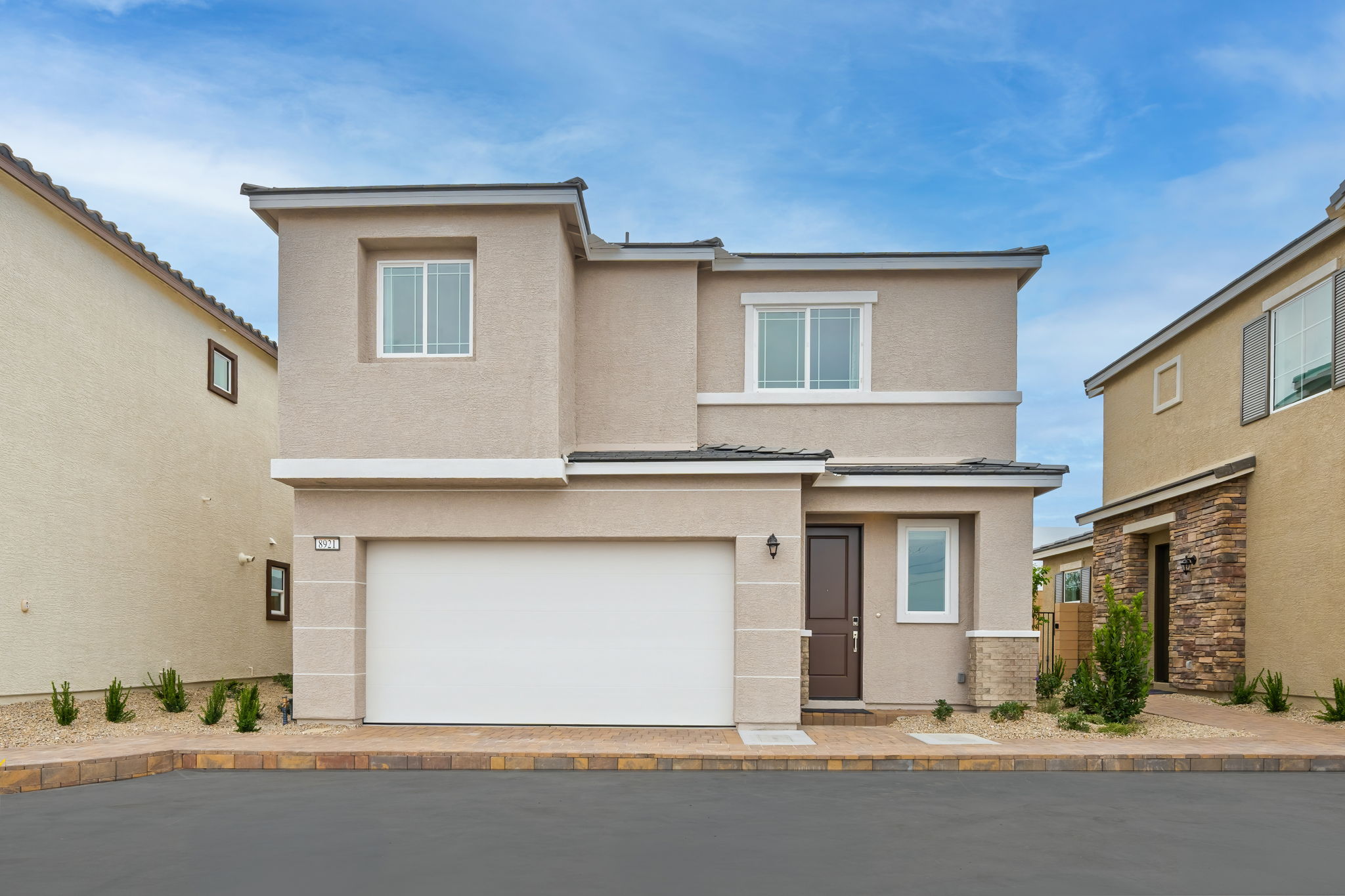 A white house with a garage.
